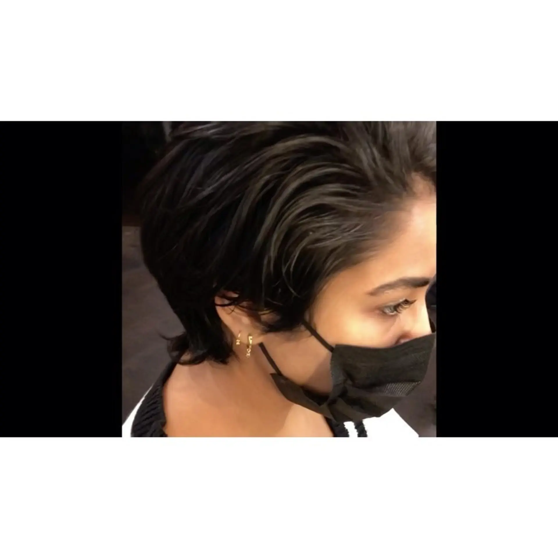 A textured dark short cut featuring tapered layers swept back with length left at the nape. 1