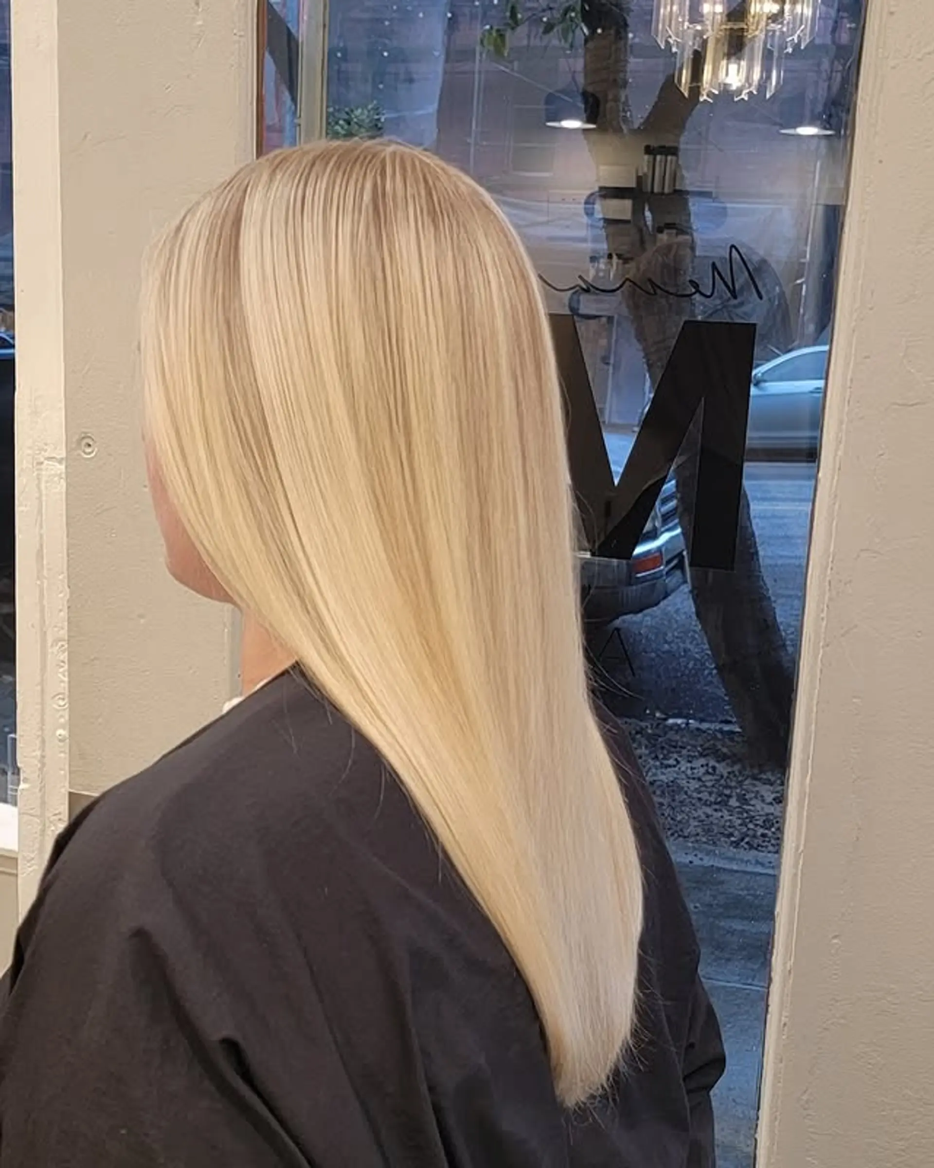 Long, straight hair with a blunt cut, showcasing a beautiful rooted platinum blonde color that seamlessly blends into a darker, natural-looking root. 1