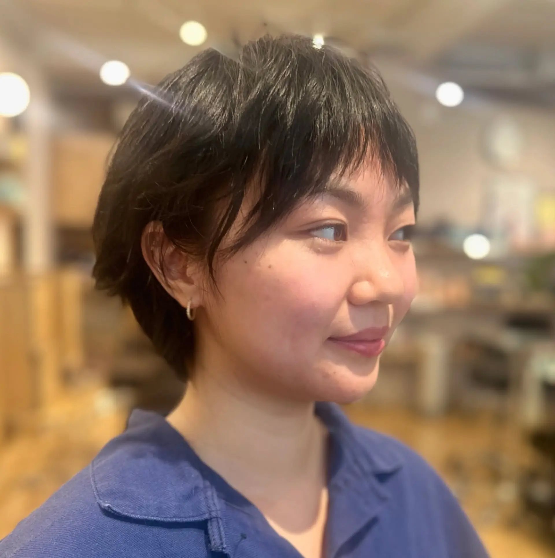 A textured bixie haircut featuring short, piecey micro bangs and soft, tapered shaping around the ears. 1