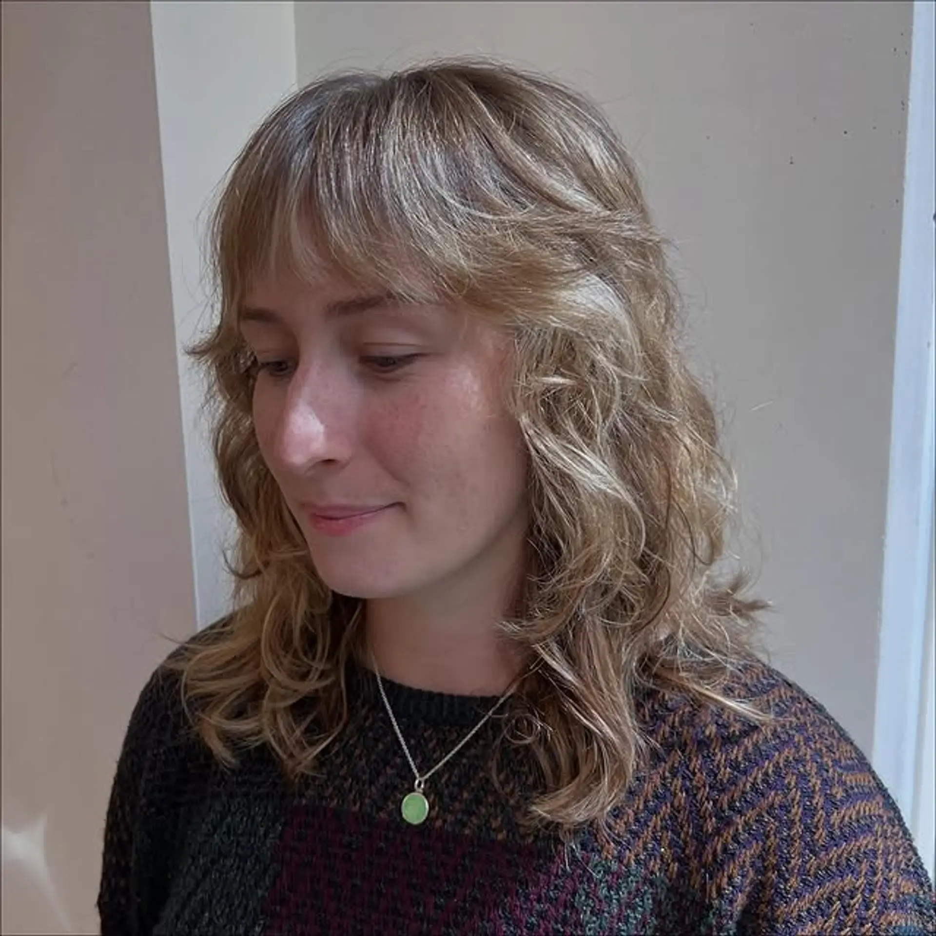 A modern shag haircut with curtain bangs and soft, natural waves. 1