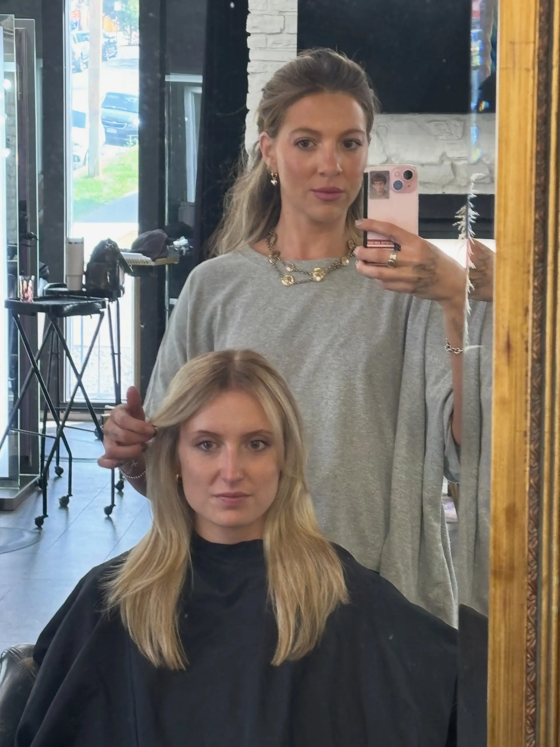 Medium-length blonde hair styled sleek and straight with a middle part and face-framing layers. 1