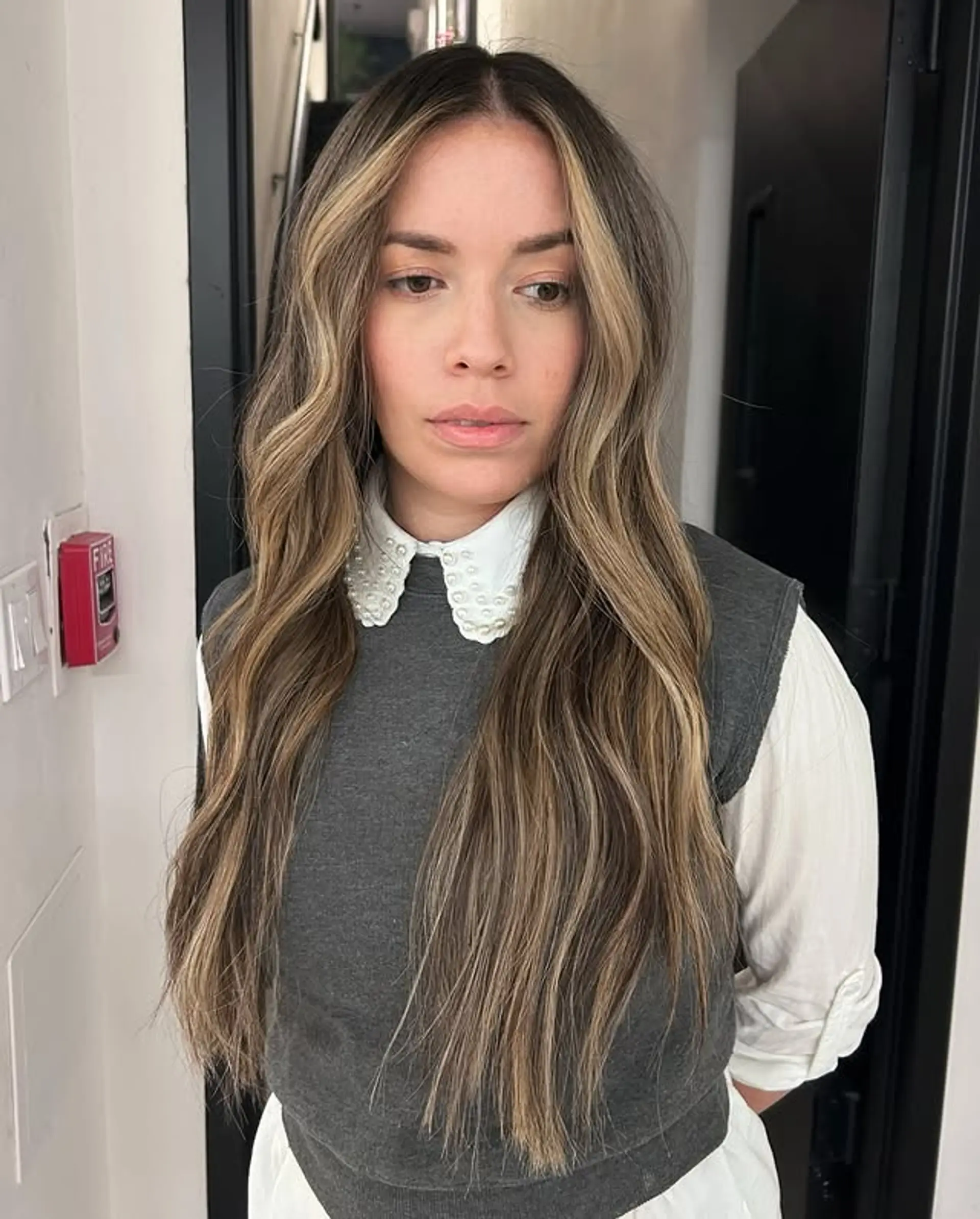 Long, wavy hair with a blonde balayage, creating a beachy, natural look. 1