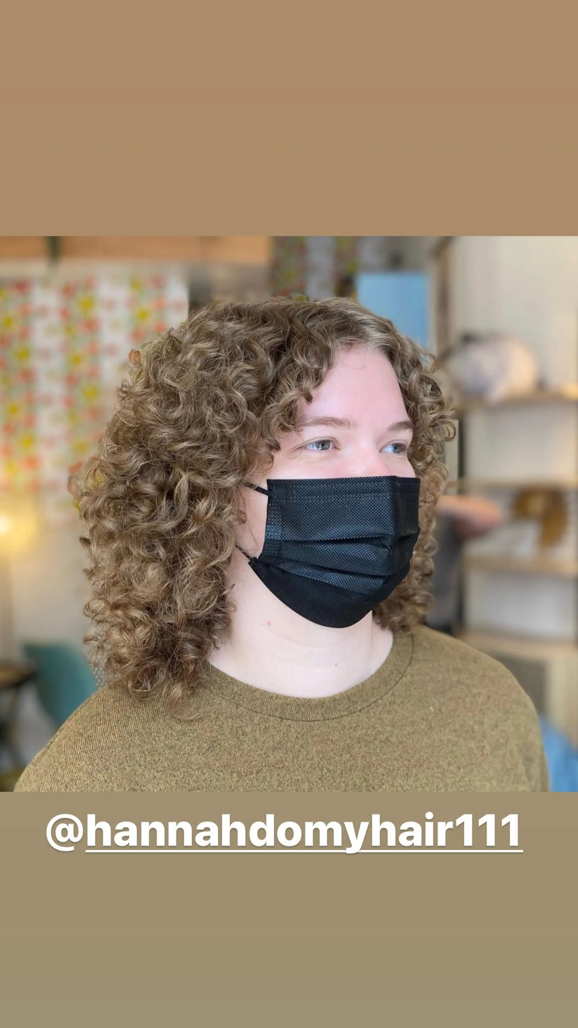 A curly bob with layers to enhance the natural curl pattern and dimensional blonde highlights. 1