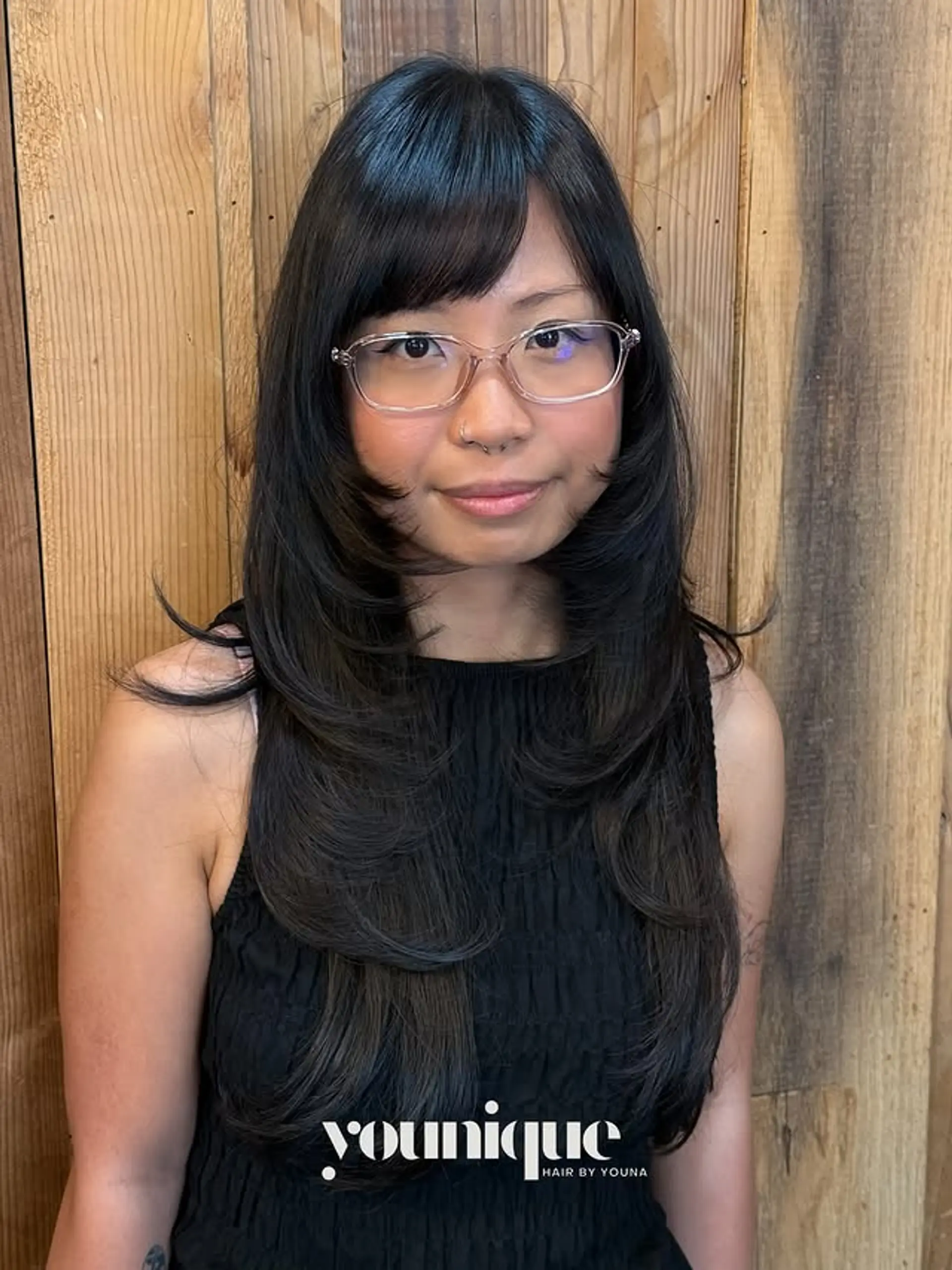 A long hairstyle with curtain bangs and face-framing layers. 1