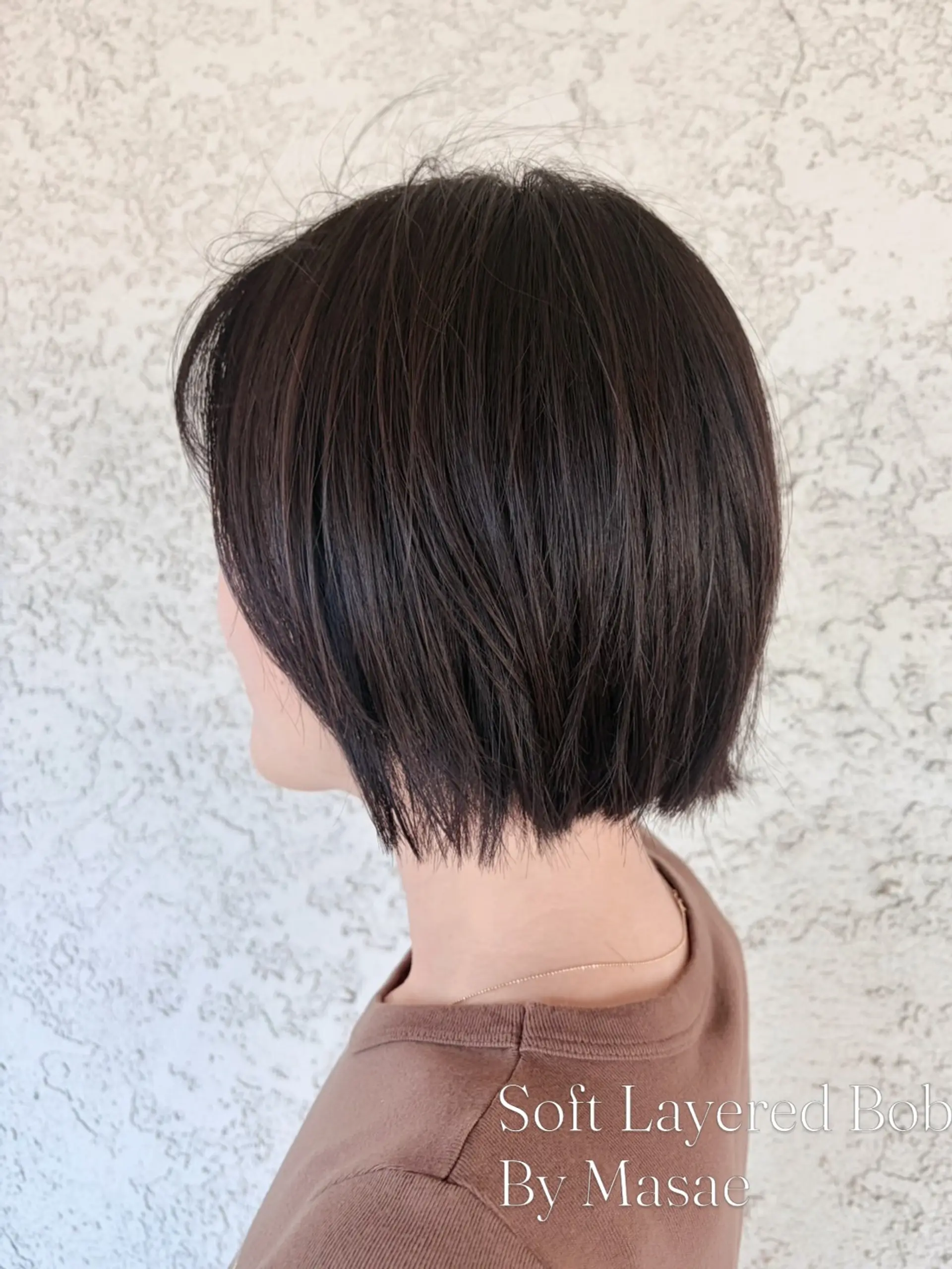 A soft, textured short bob featuring subtle layers and a gently rounded shape. 1