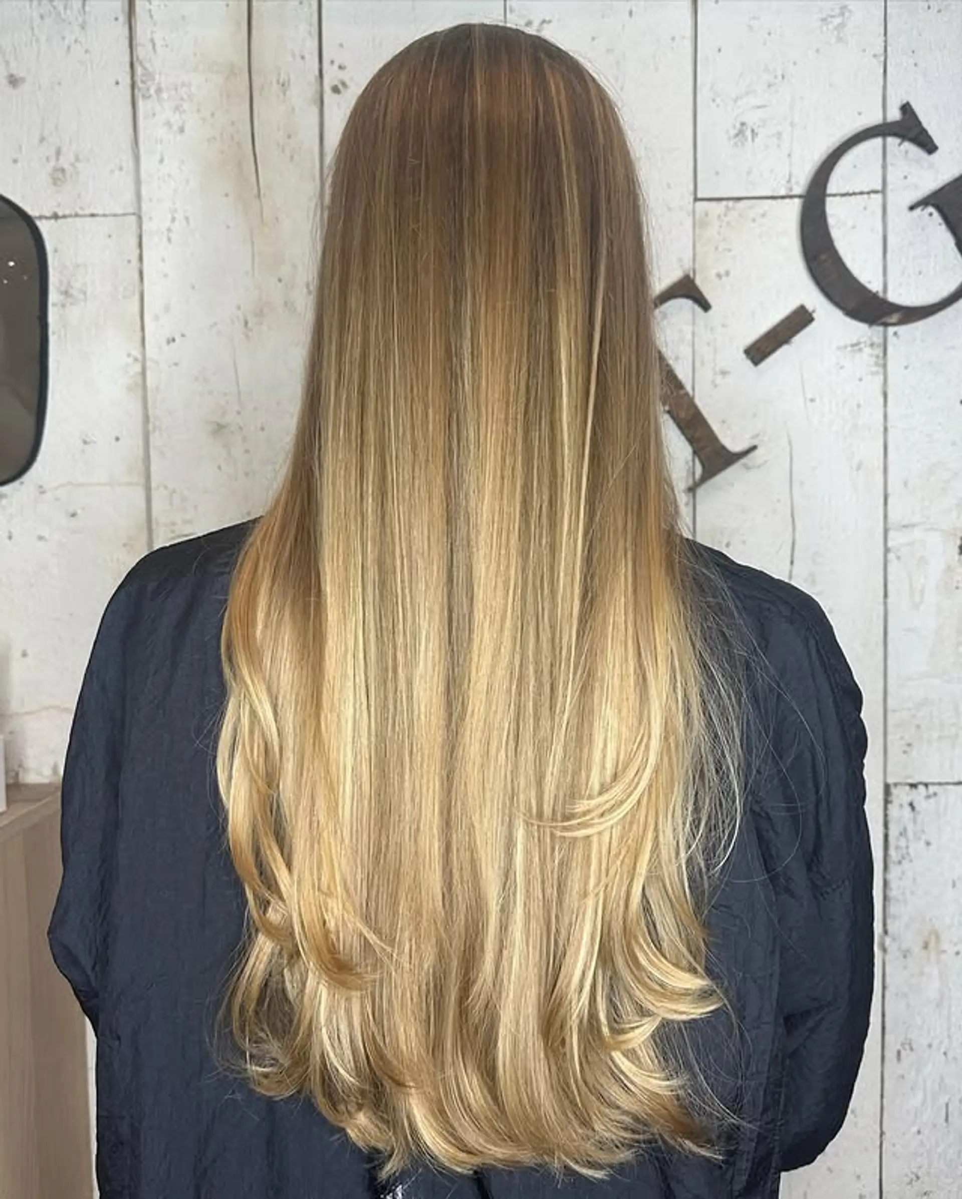 Long, layered hairstyle with soft, cascading layers. 1