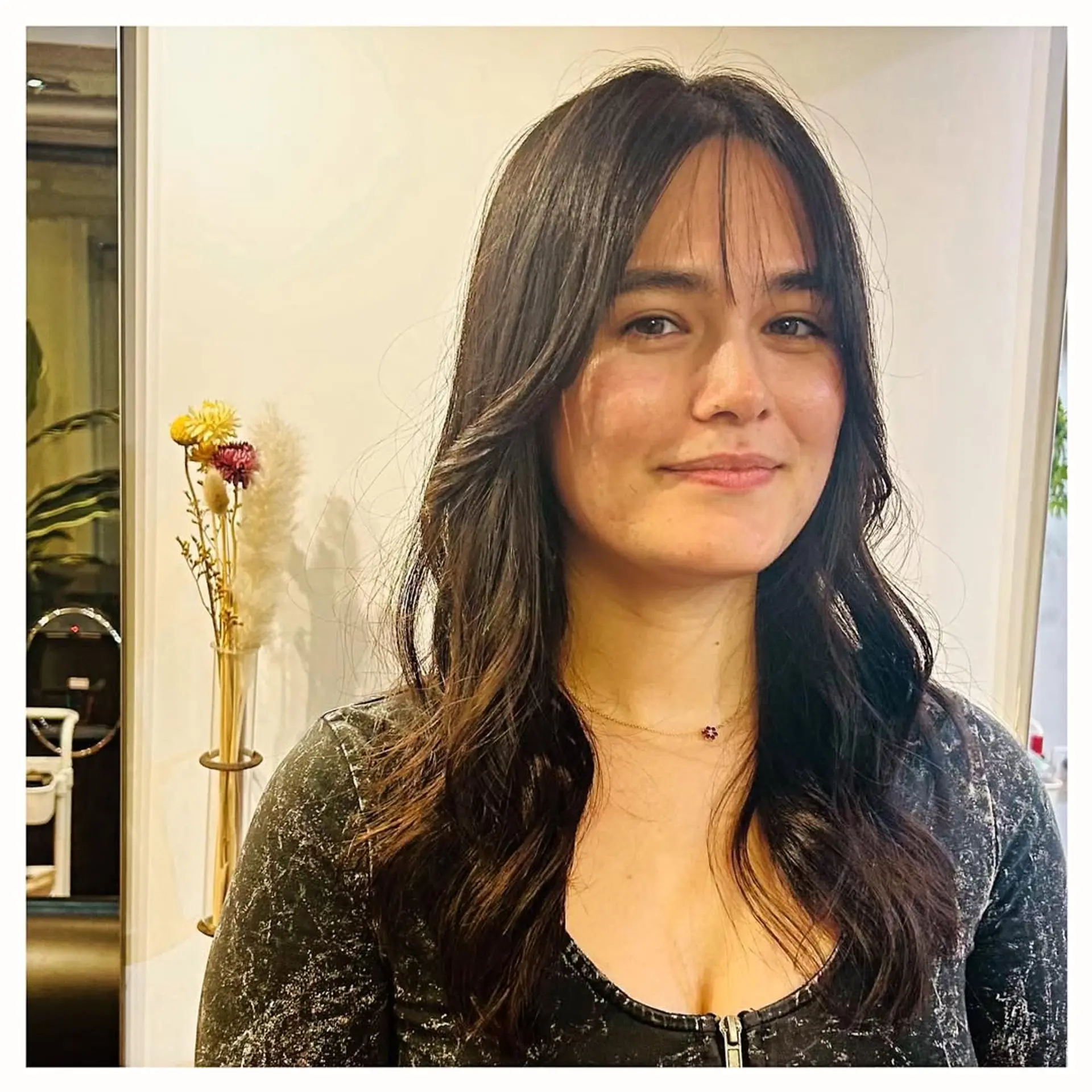 A long, wavy hairstyle featuring curtain bangs and face-framing layers. 1