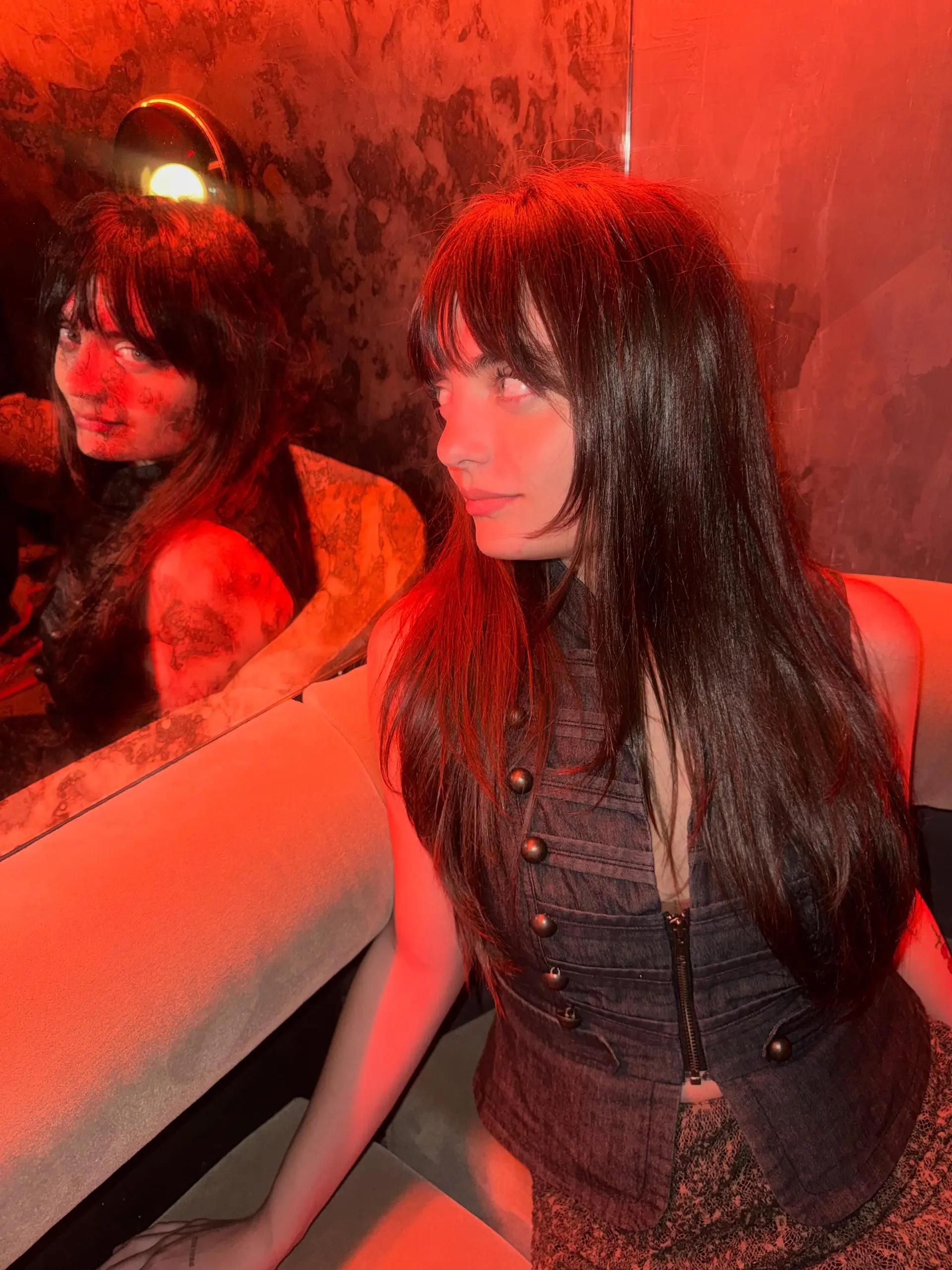 A long, dark brown razor cut styled straight with textured face-framing layers and a full eyebrow-skimming fringe. 1