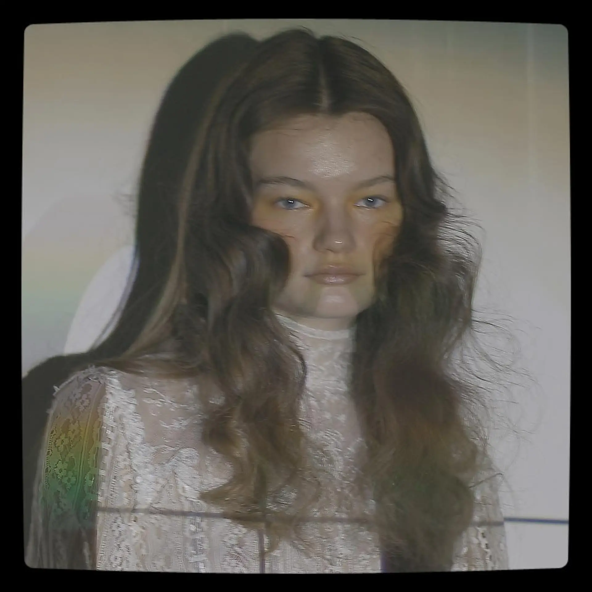 Center-parted long brunette hair styled with soft, brushed-out retro waves providing airy volume and subtle texture. 1