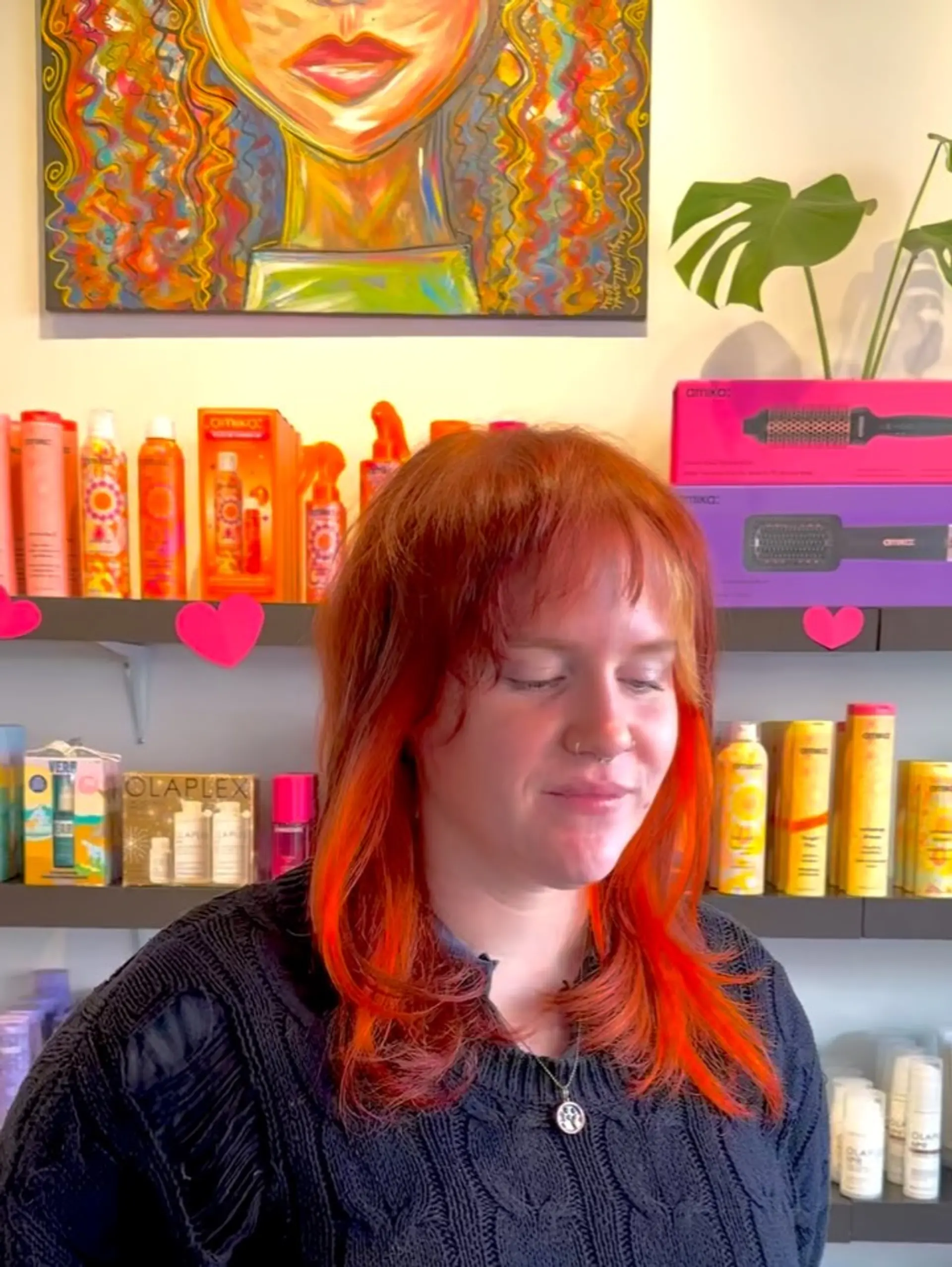 A modern shaggy mullet haircut featuring piecey bangs, textured layers, and a vibrant neon copper and orange tone. 1