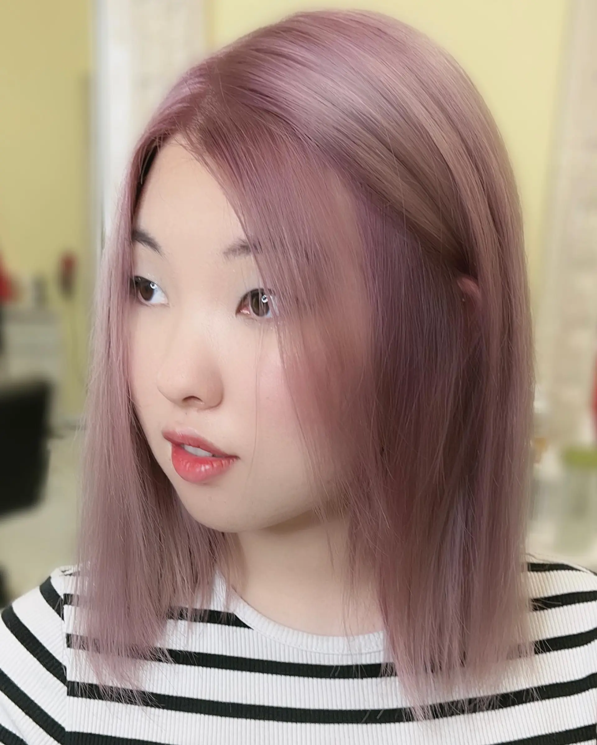 A medium-length blunt bob cut in a trendy dusty rose color. 1