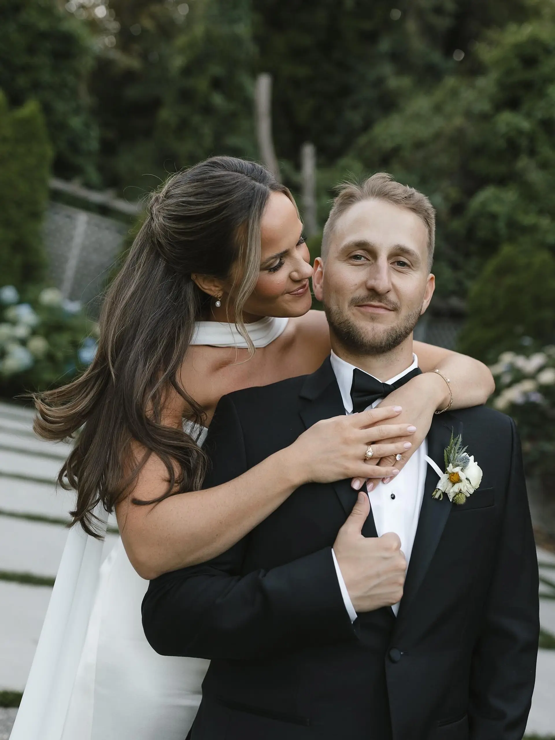 An elegant bridal half-up, half-down hairstyle featuring voluminous waves, pinned crown section, and soft face-framing strands. 1
