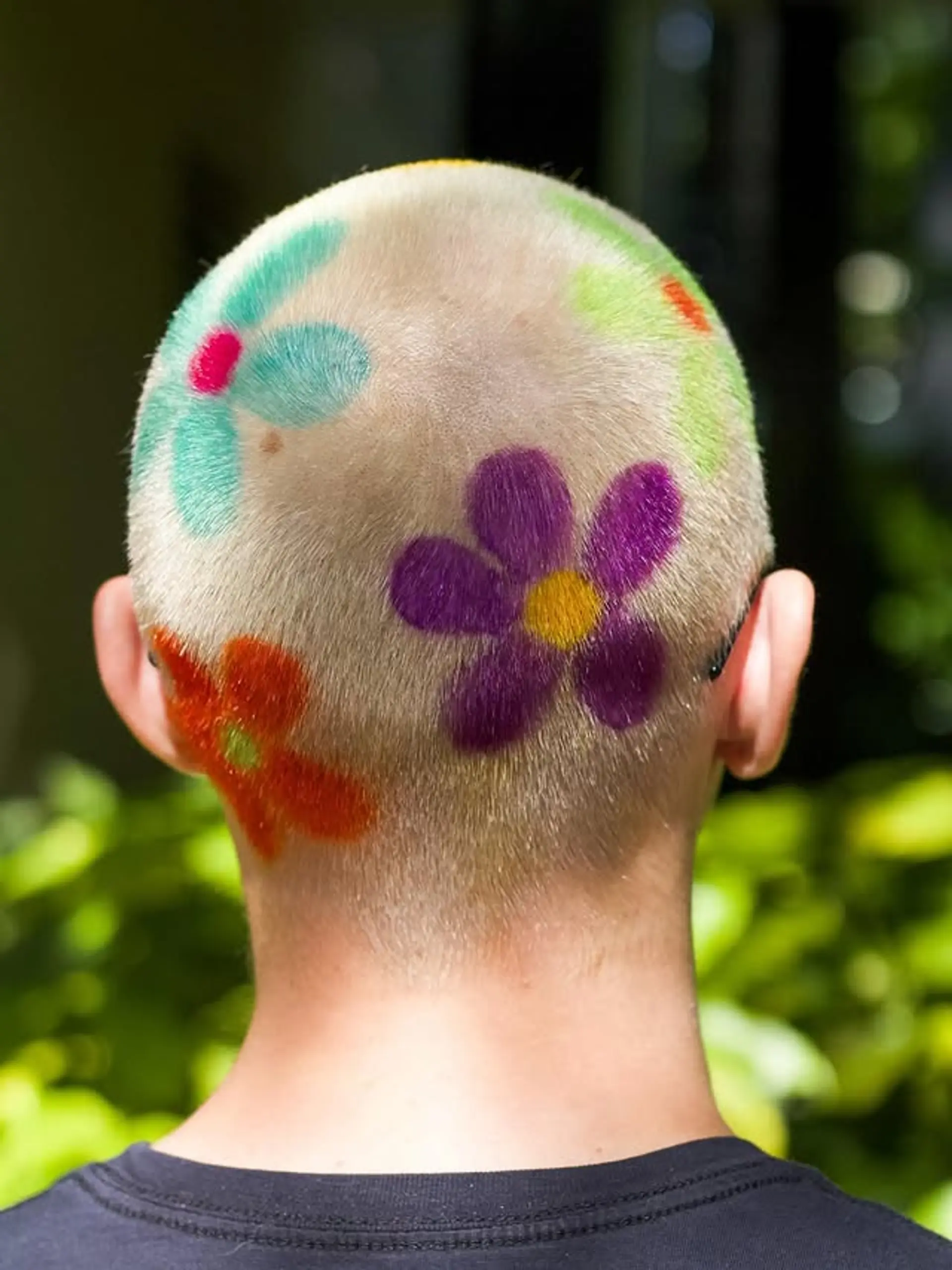 A buzz cut elevated with colorful floral hair art. 1