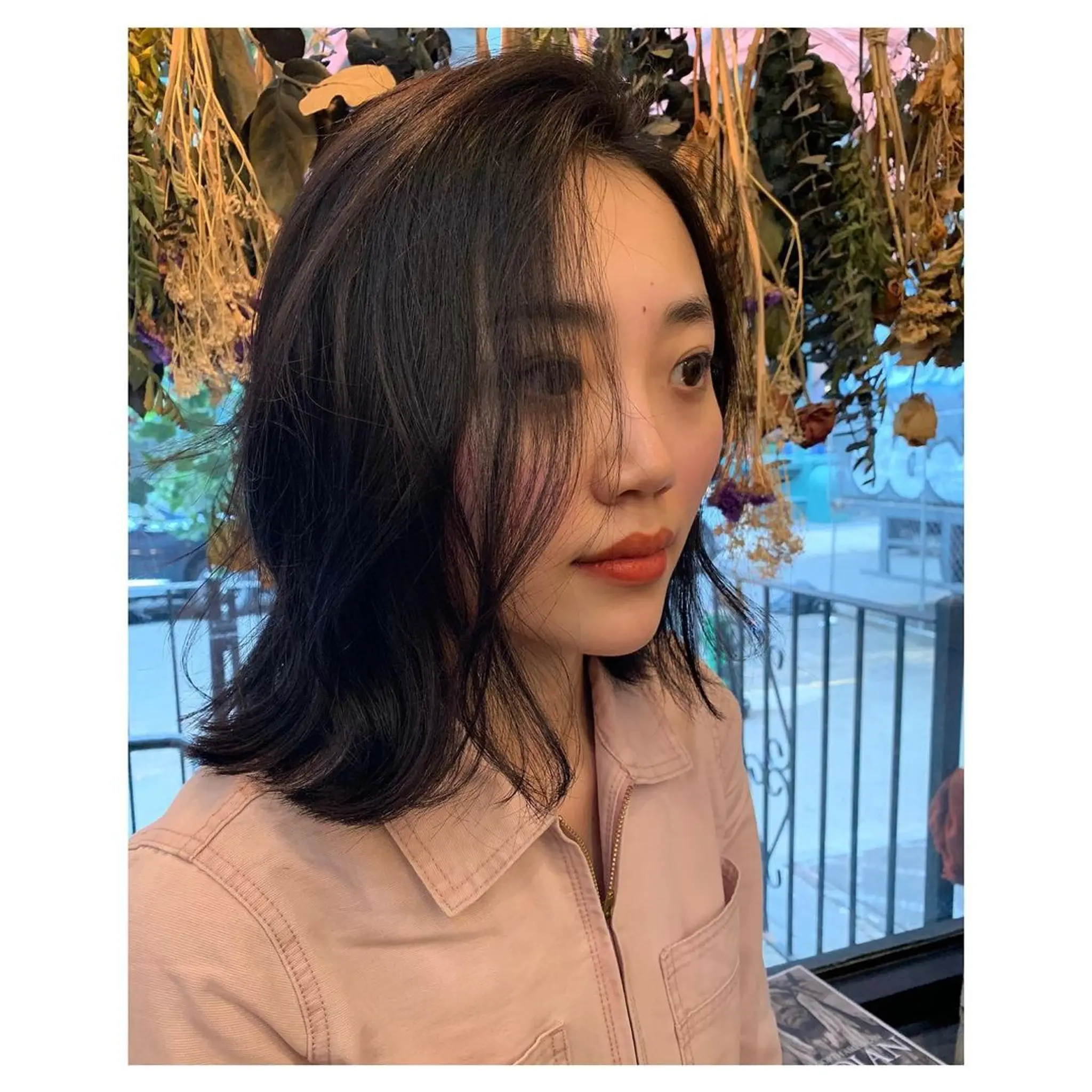 A wavy, medium-length hairstyle with natural shine, subtle layers, and tousled waves, framing the face beautifully. A super long bob, also known as a Lob!
