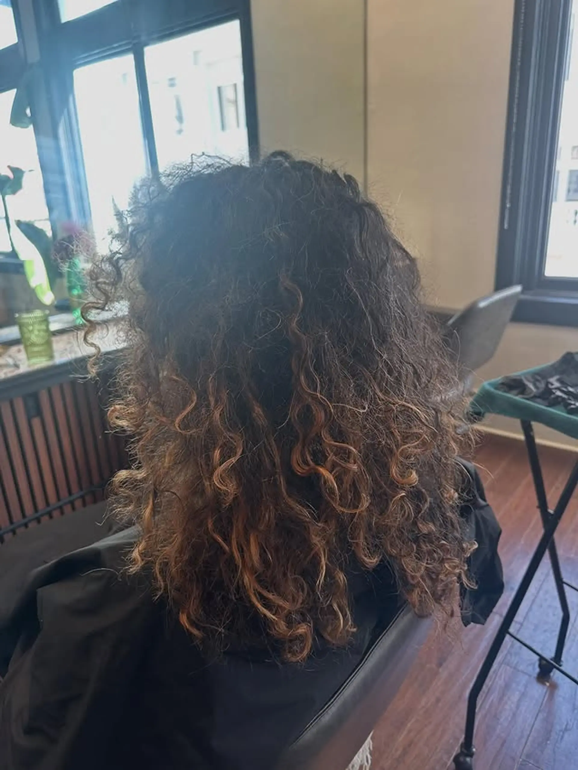 A curly lob with balayage highlights. 1