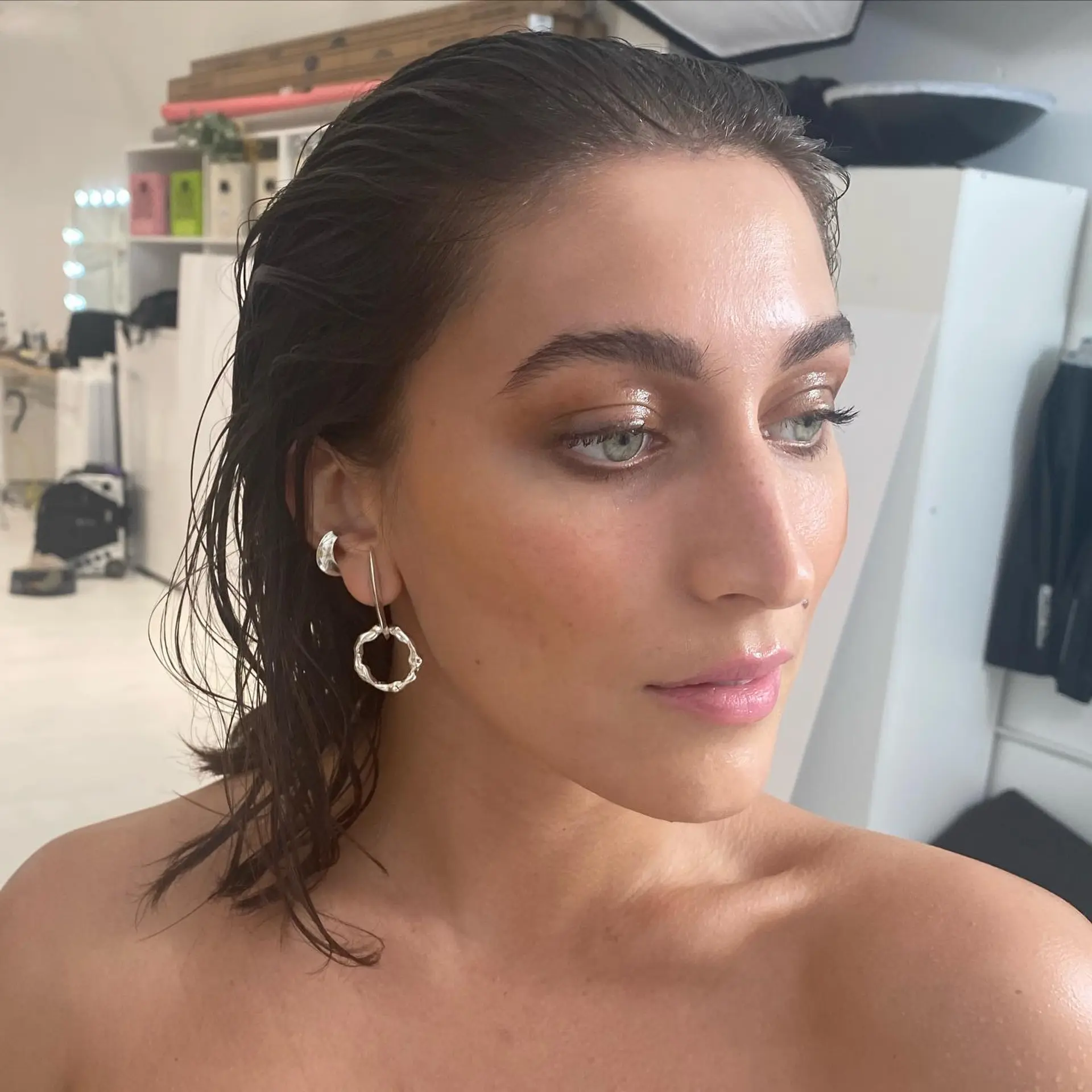 A high-gloss wet-look hairstyle slicked cleanly straight back away from the face. 1