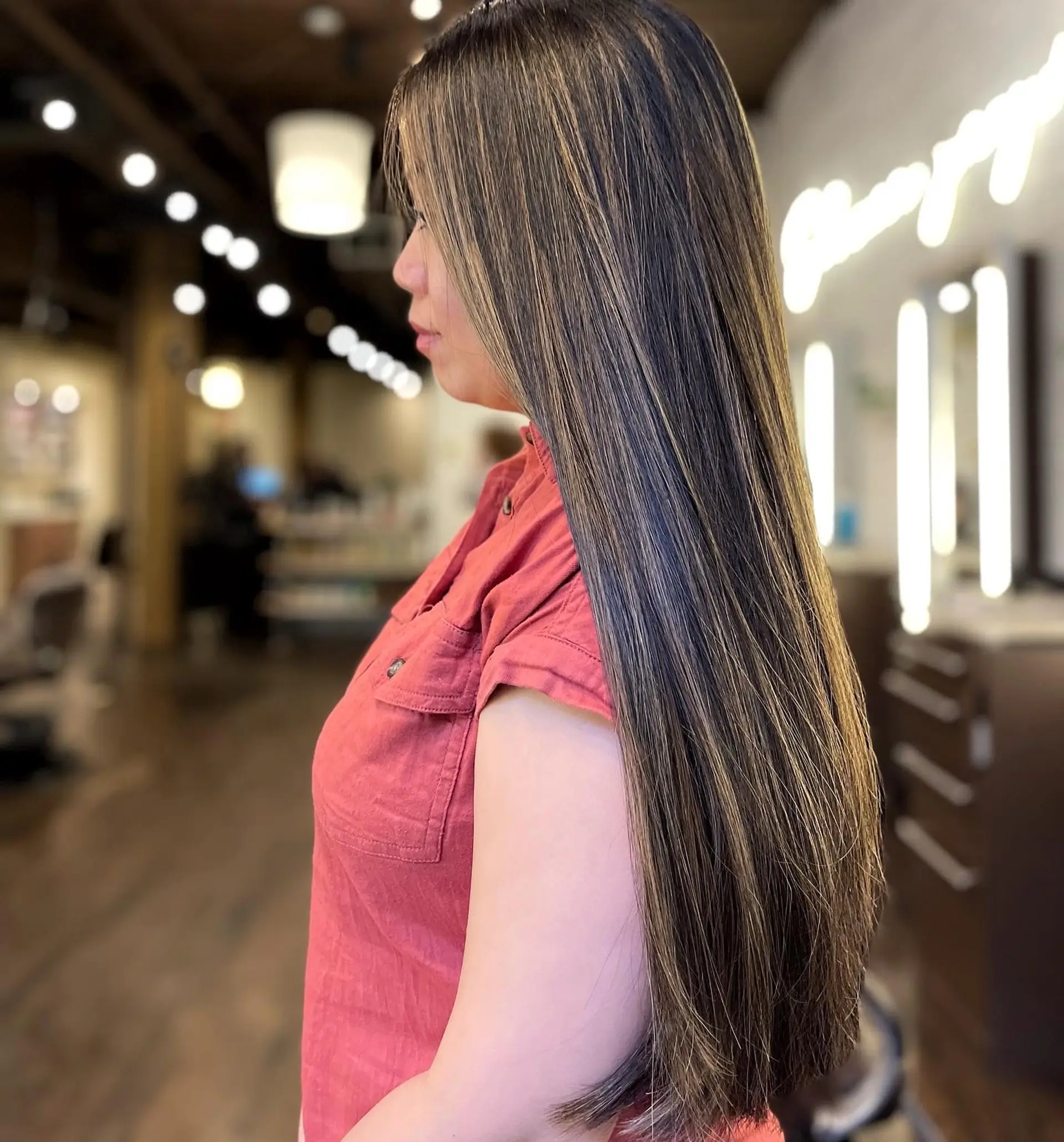 Very long, straight hairstyle with a bronde balayage and subtle layers. 1
