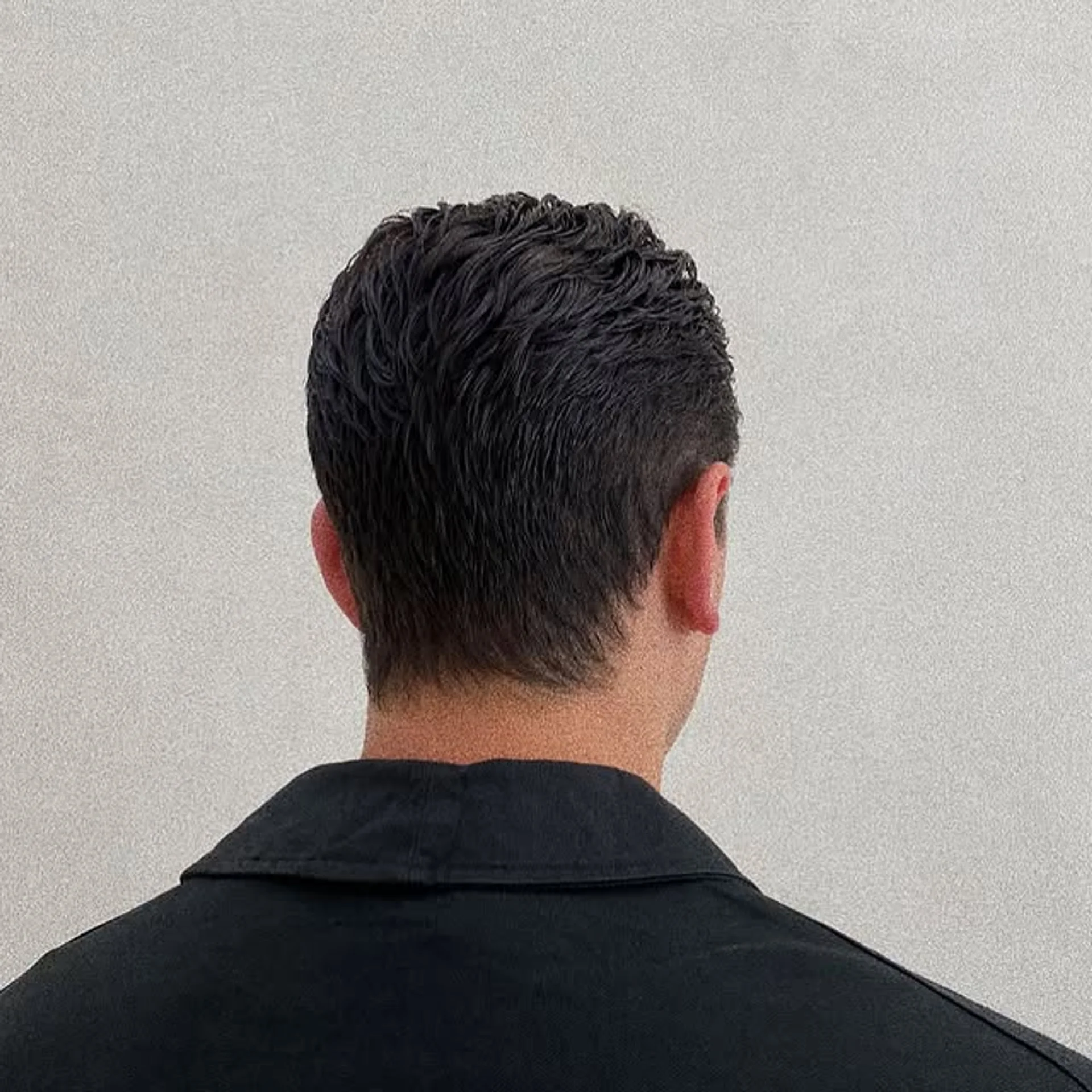 Man with a textured pompadour haircut and a neatly trimmed beard - Preview 2