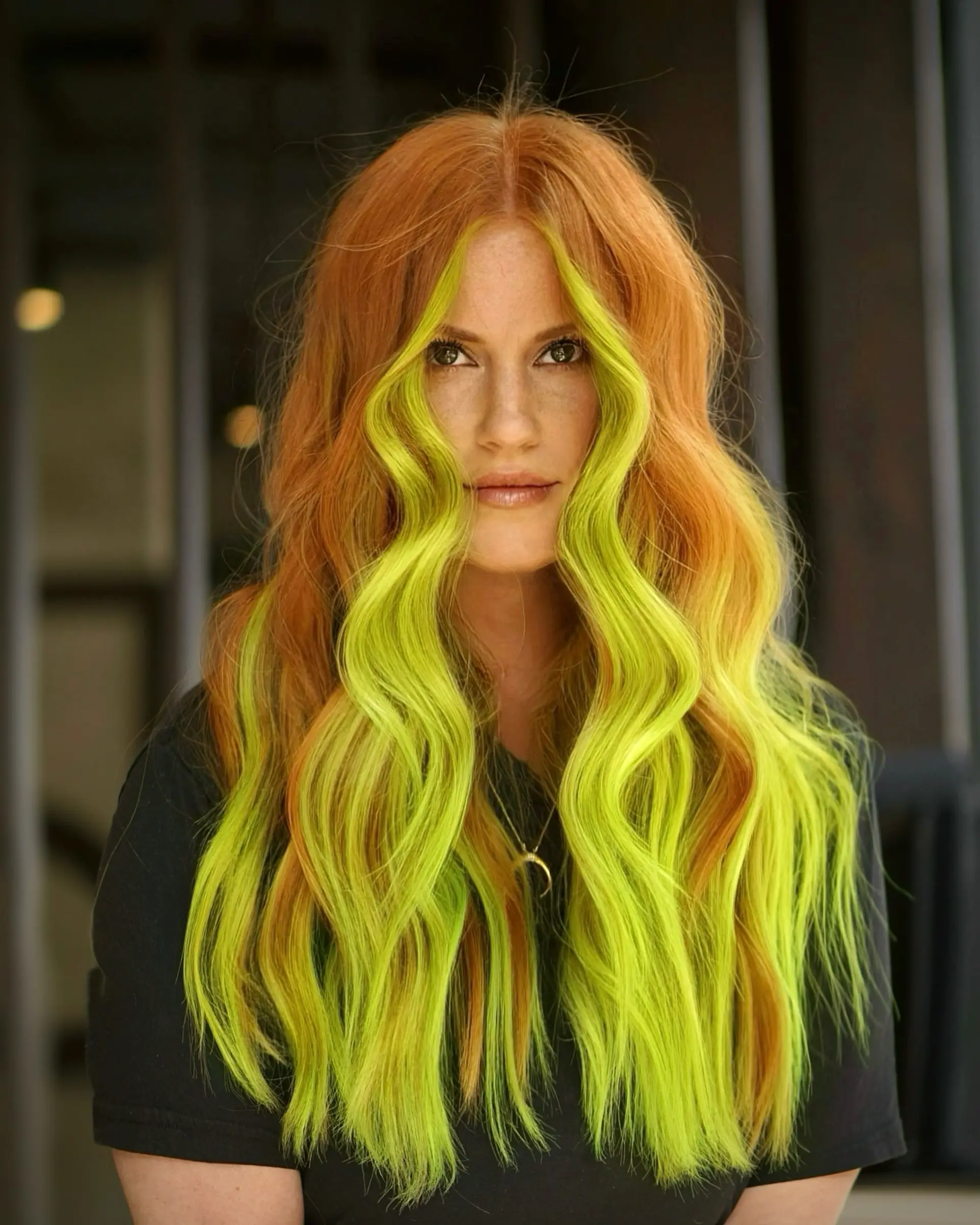 Long copper waves featuring a high-contrast, electric neon green face-framing money piece. 1
