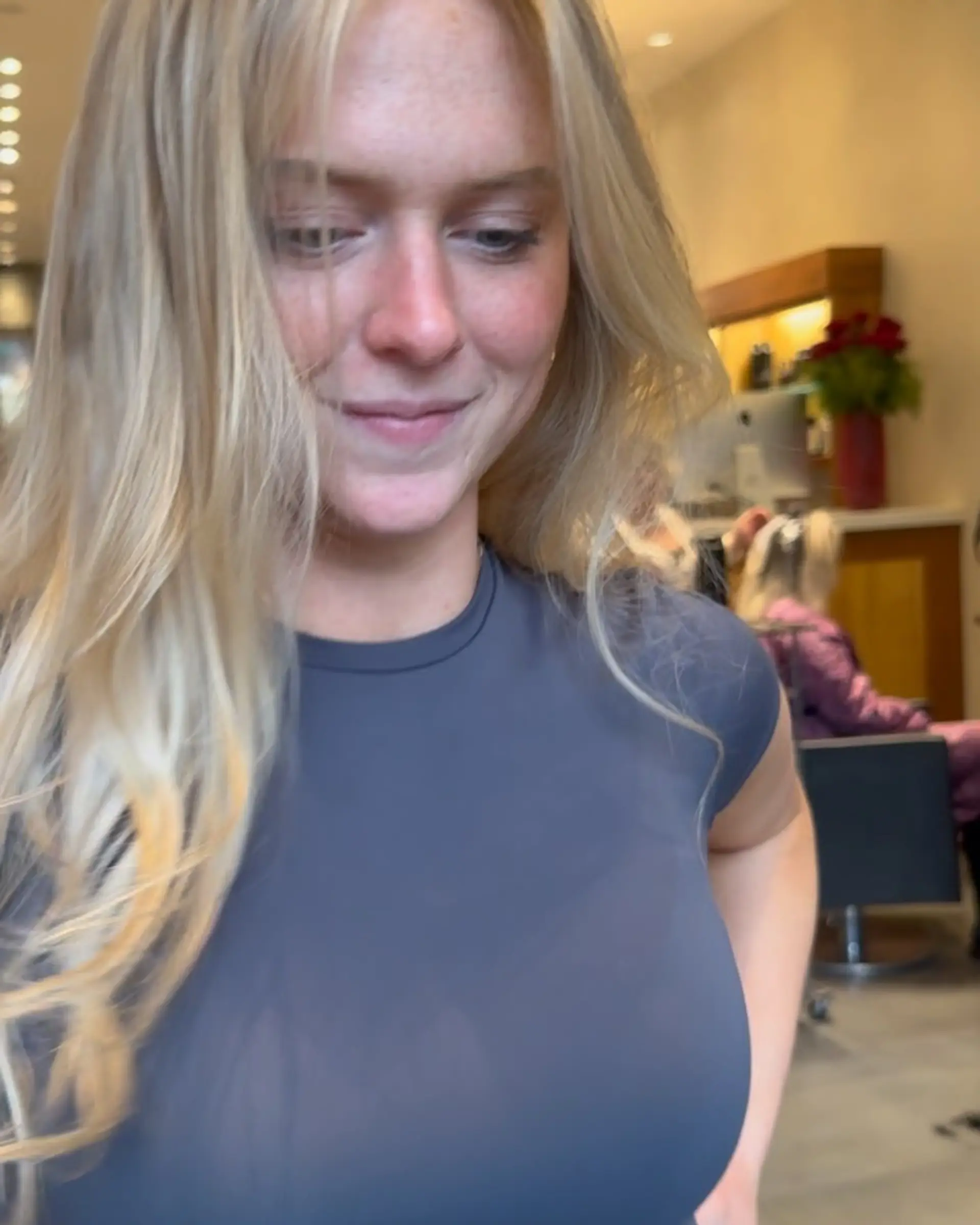 Long bright blonde hair styled in loose, soft waves with face-framing fringe. 1