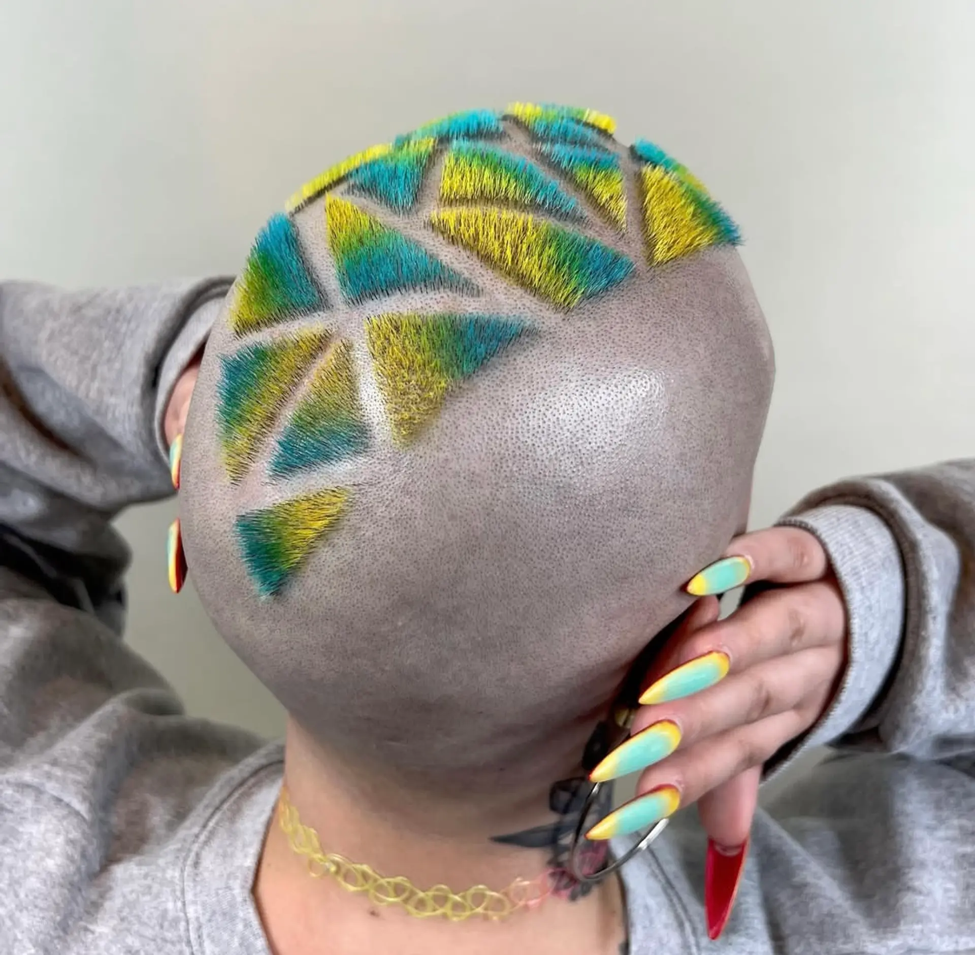 Very short buzz cut with geometric patterns and vibrant yellow, blue, and green colors. 1