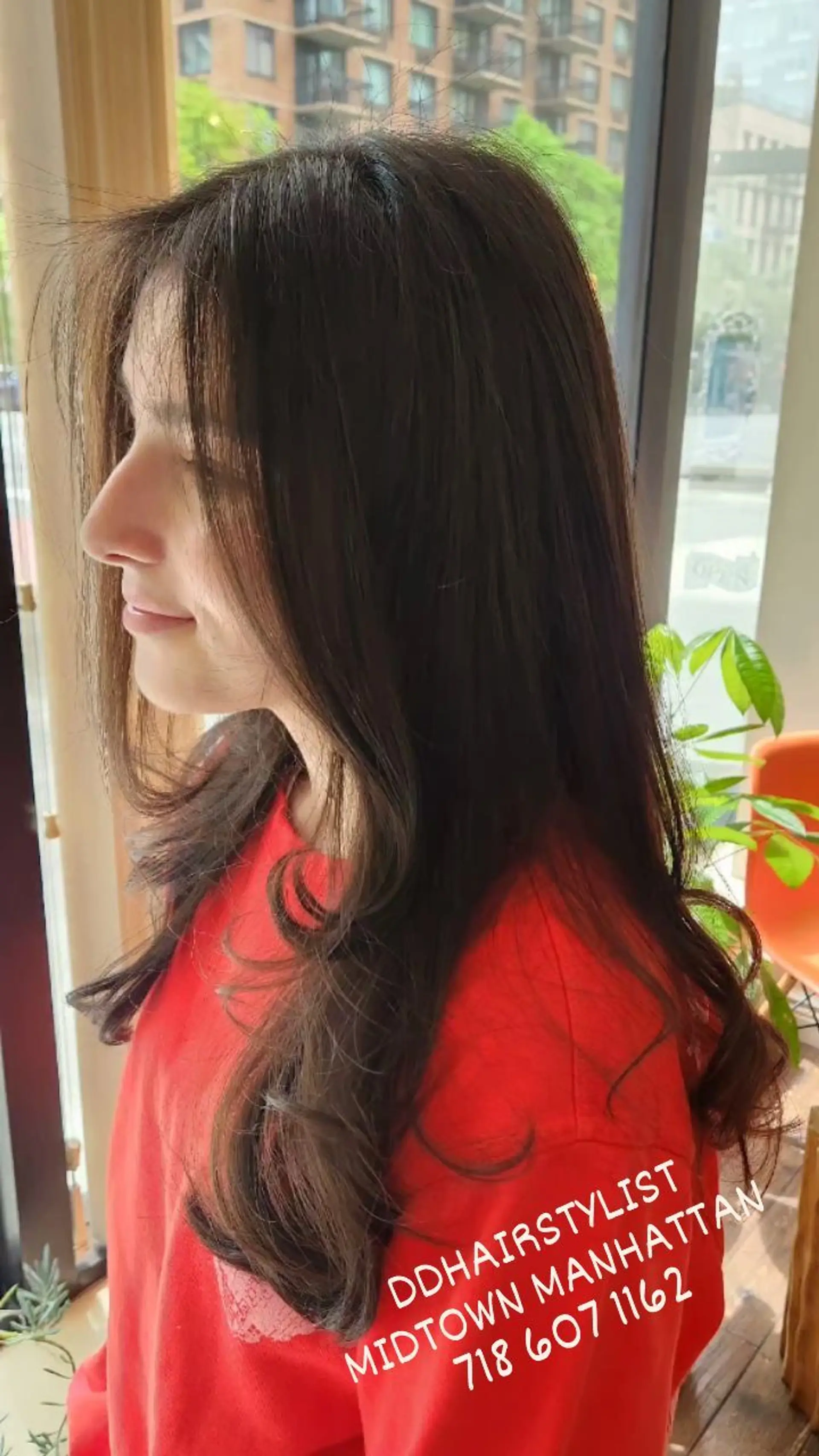 Long dark brown hair cut in soft layers with gentle, bouncy curls at the ends and face-framing fringe. 1