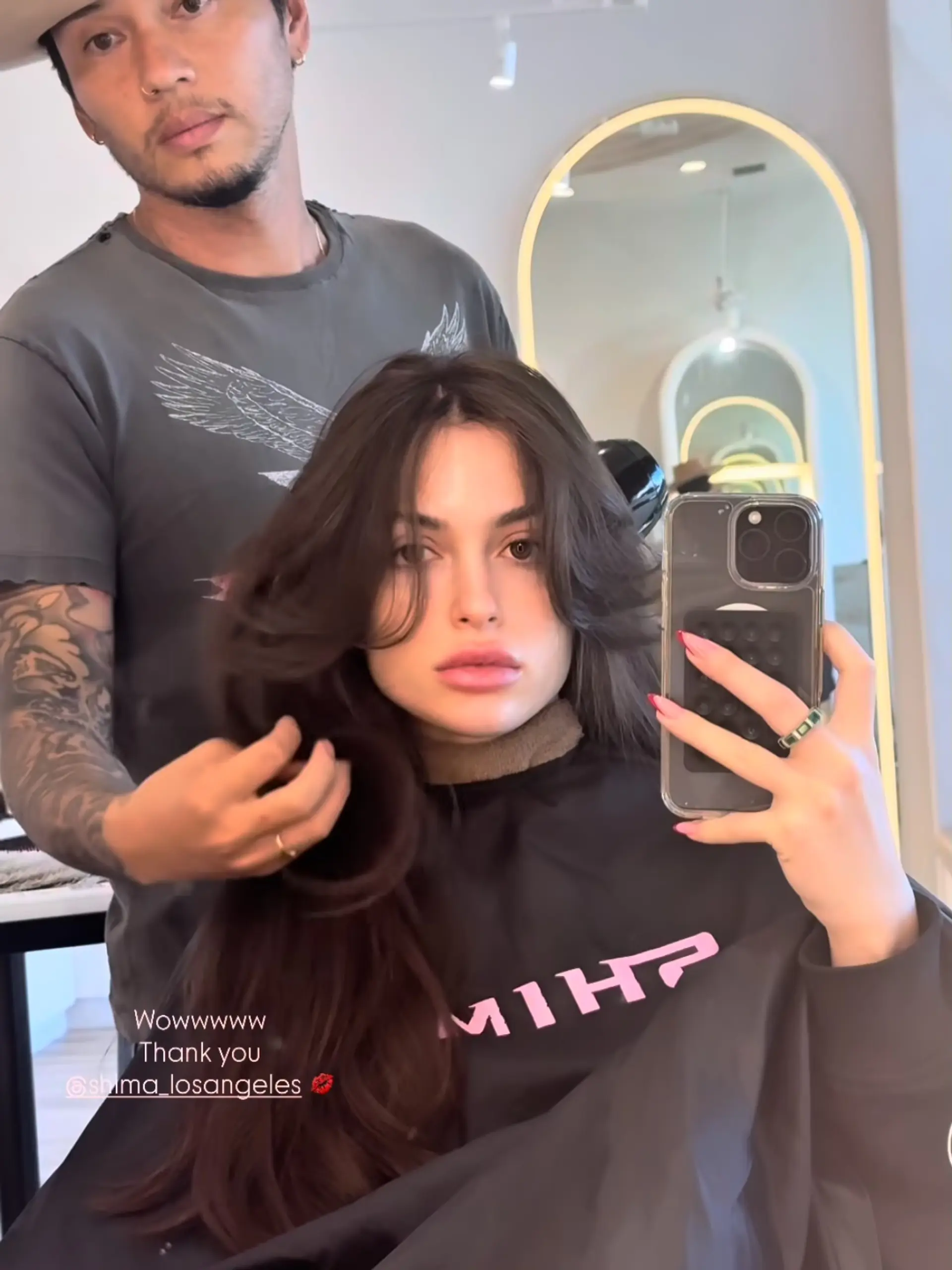 Voluminous long layered haircut featuring feathered curtain bangs and soft blowout waves. 1
