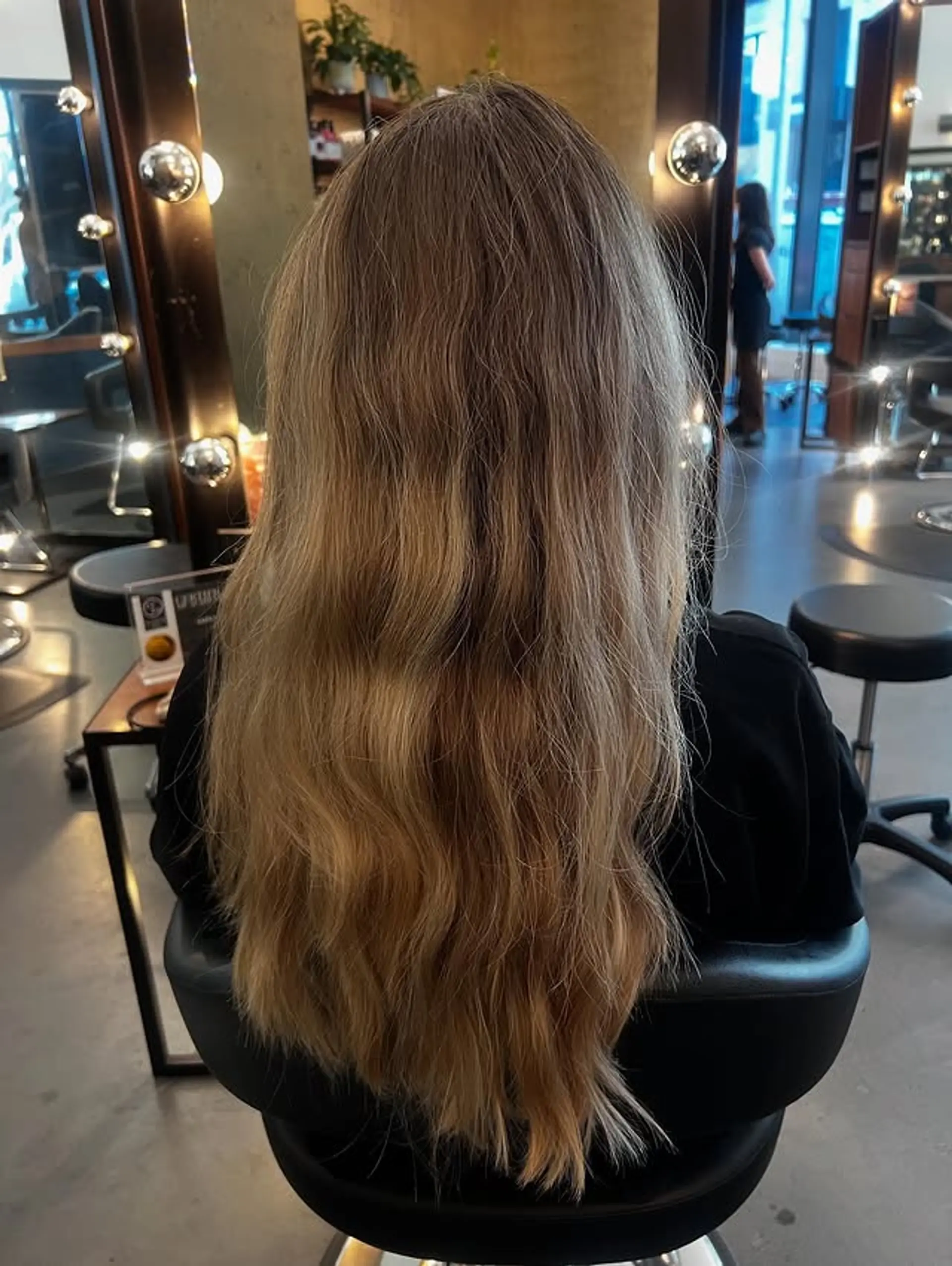 Long layered hairstyle with beachy waves and a subtle balayage. 1