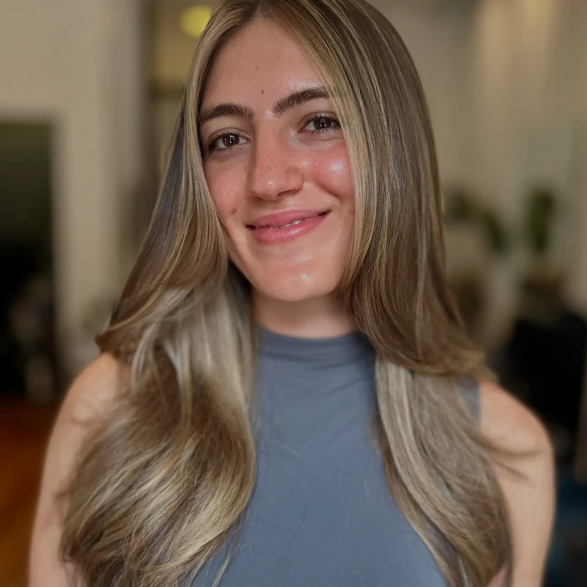Long layered hair styled with a smooth blowout and soft, face-framing blonde highlights. 1