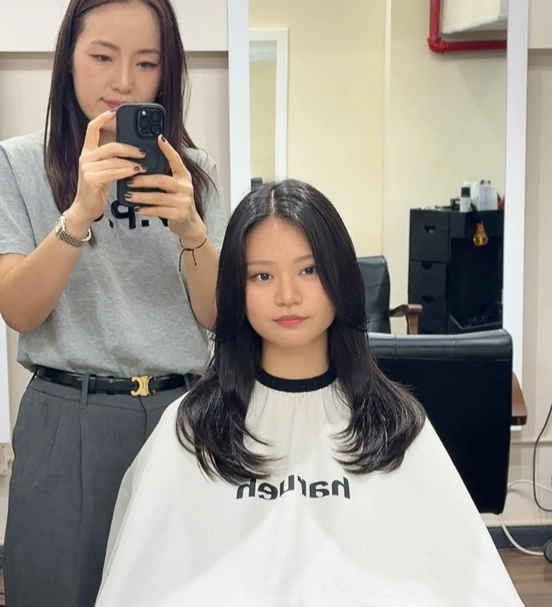 A sophisticated layered cut featuring soft, face-framing layers and a subtle flip at the ends, creating a flowy, voluminous silhouette. 1