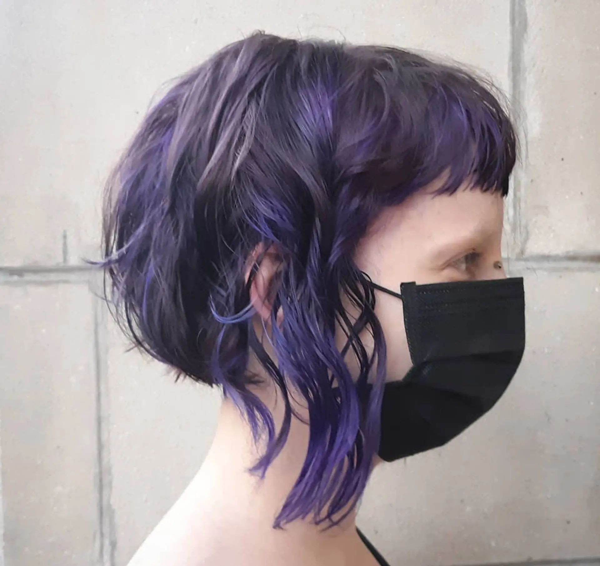 A short, wavy bob with baby bangs. 1