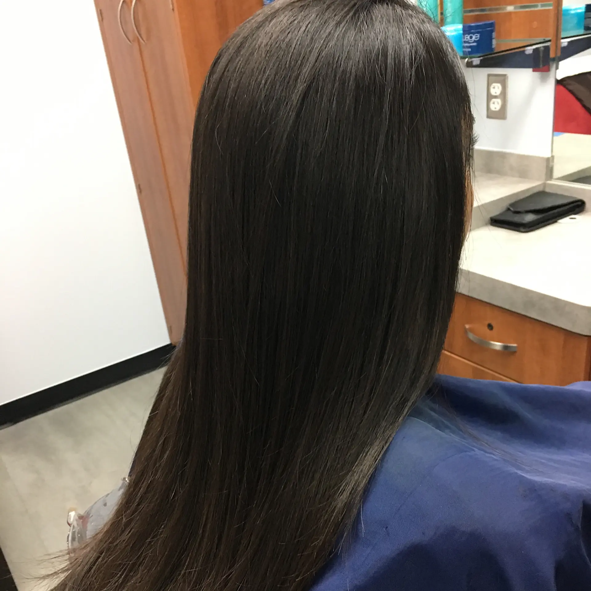 Ultra-sleek and glossy long dark hair falling straight down the back. 1