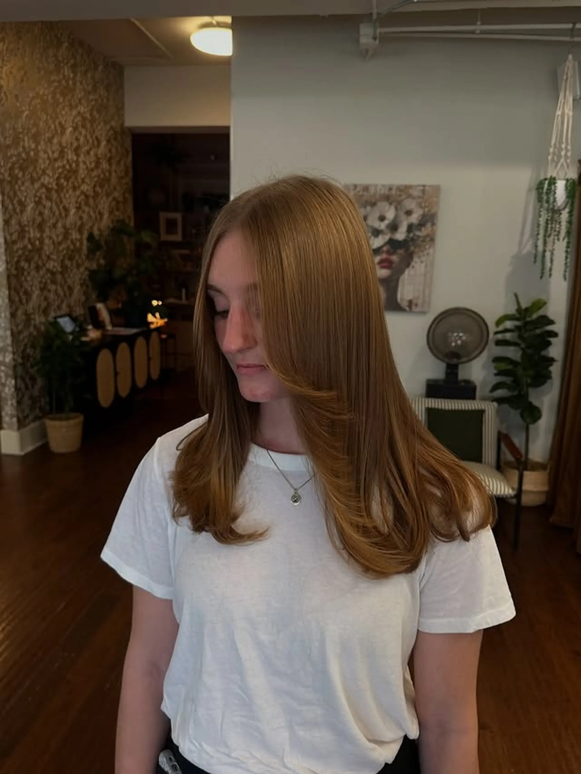 A layered medium haircut with face-framing layers for a modern look. 1