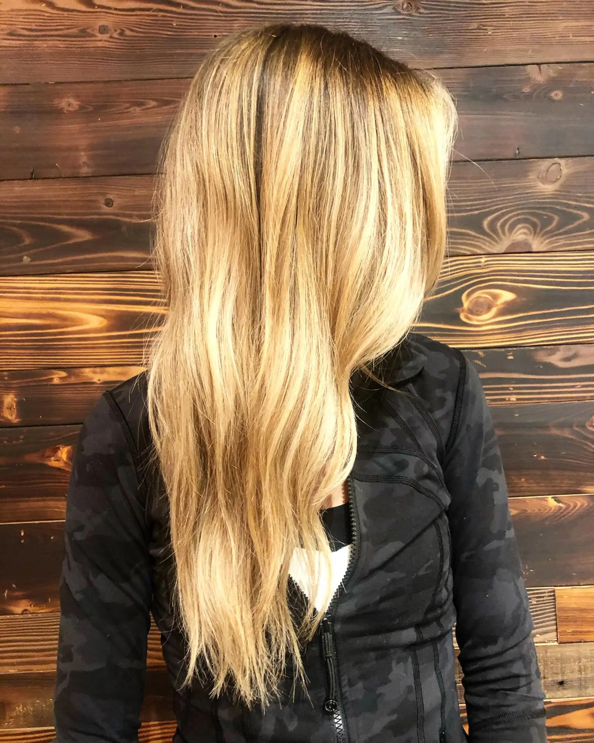 Long, layered hairstyle with a golden blonde balayage. 1