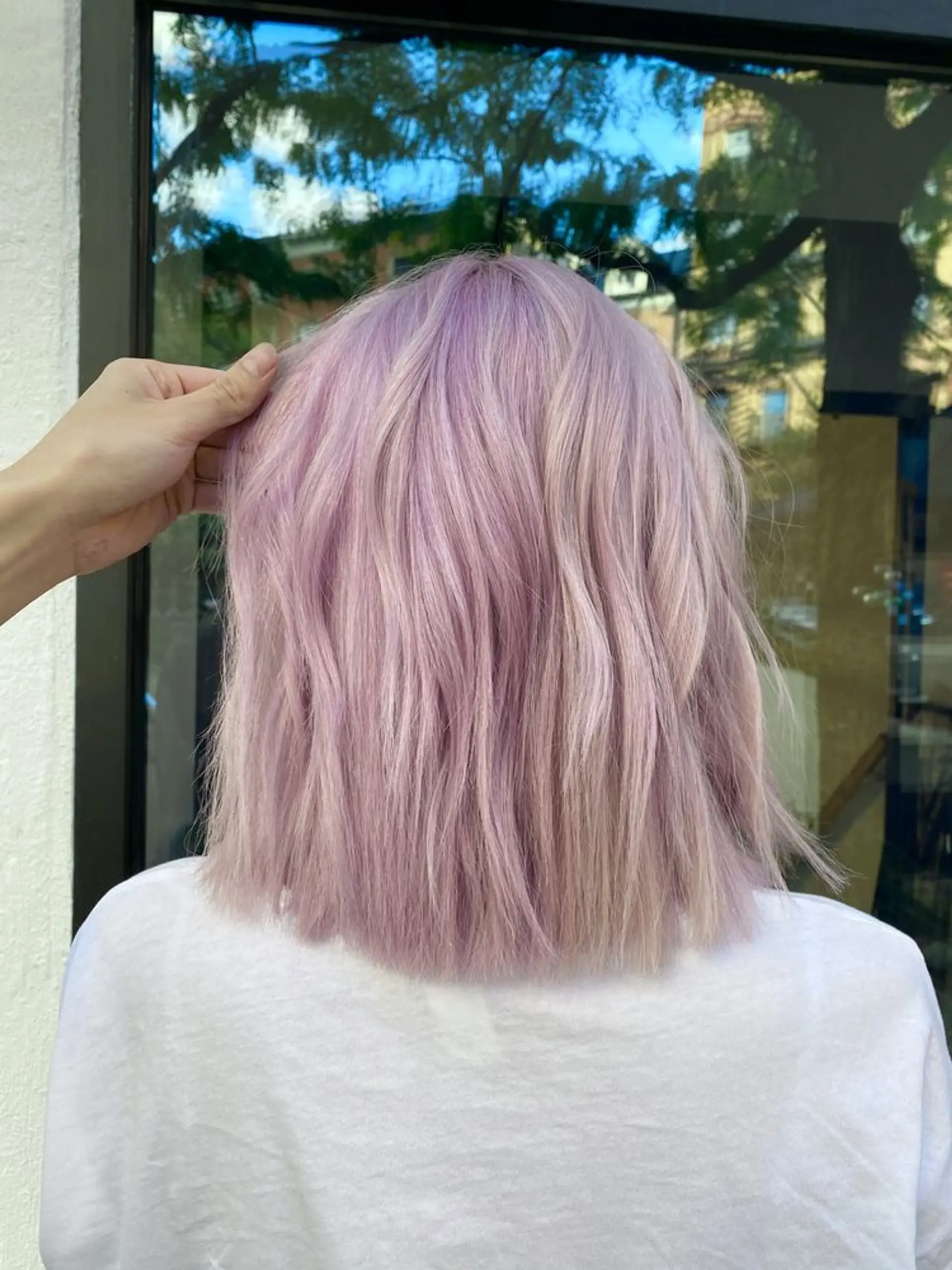 A medium-length bob with a vibrant lavender pastel color and naturally wavy texture, giving it a voluminous and carefree appearance. 1