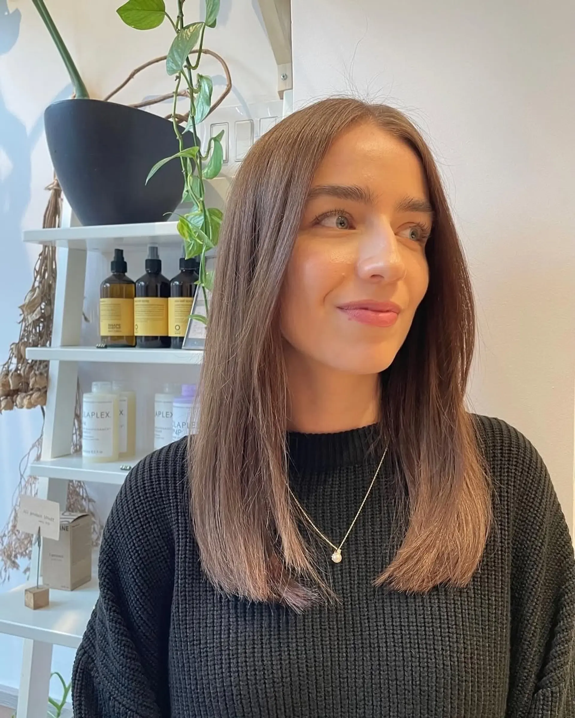 A stylish straight lob with subtle layers and a center part, featuring a brown to blonde ombre effect. 2