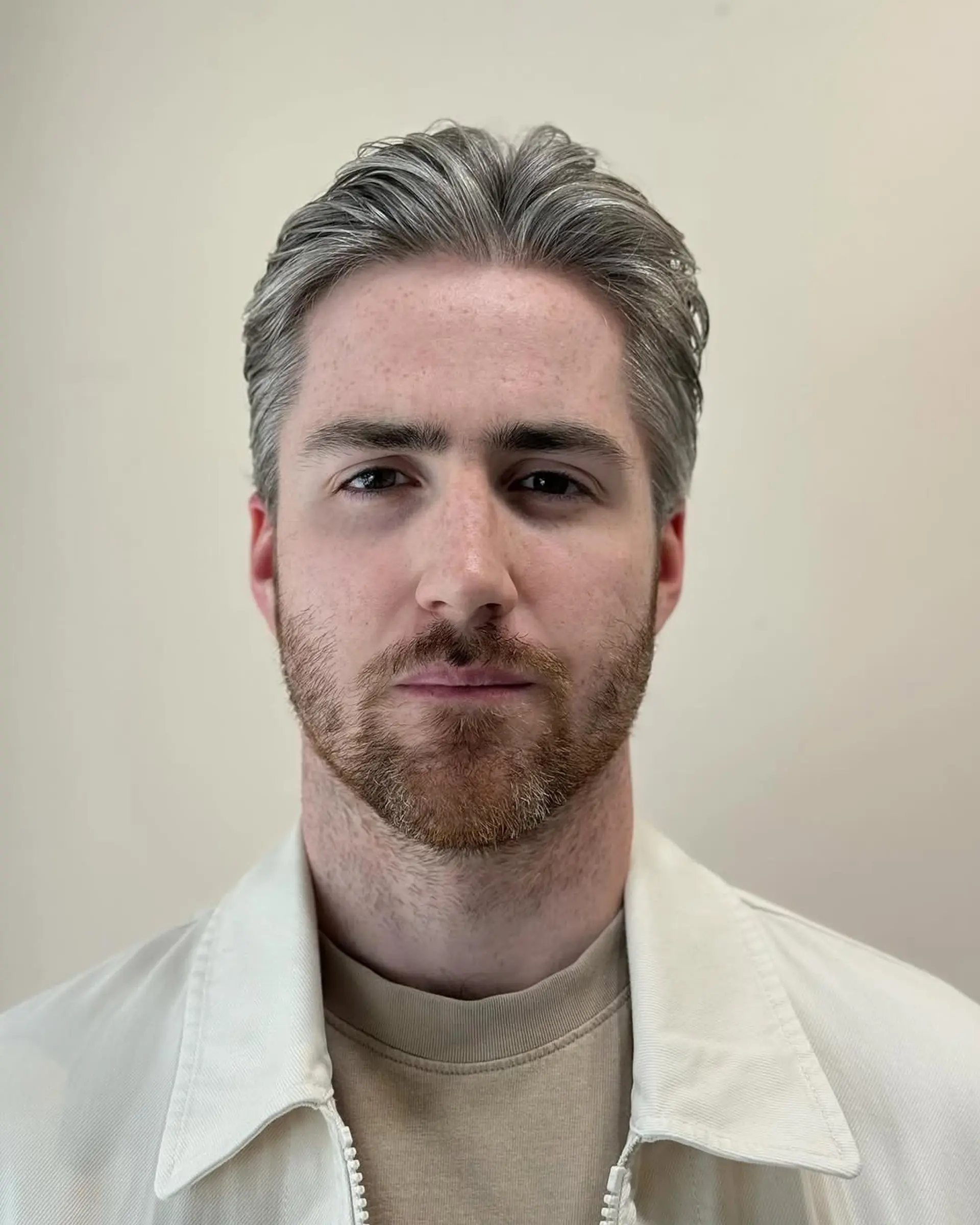 Short wavy hairstyle with a side part, featuring textured waves in silver and gray, providing a natural flow and sleek finish. 1