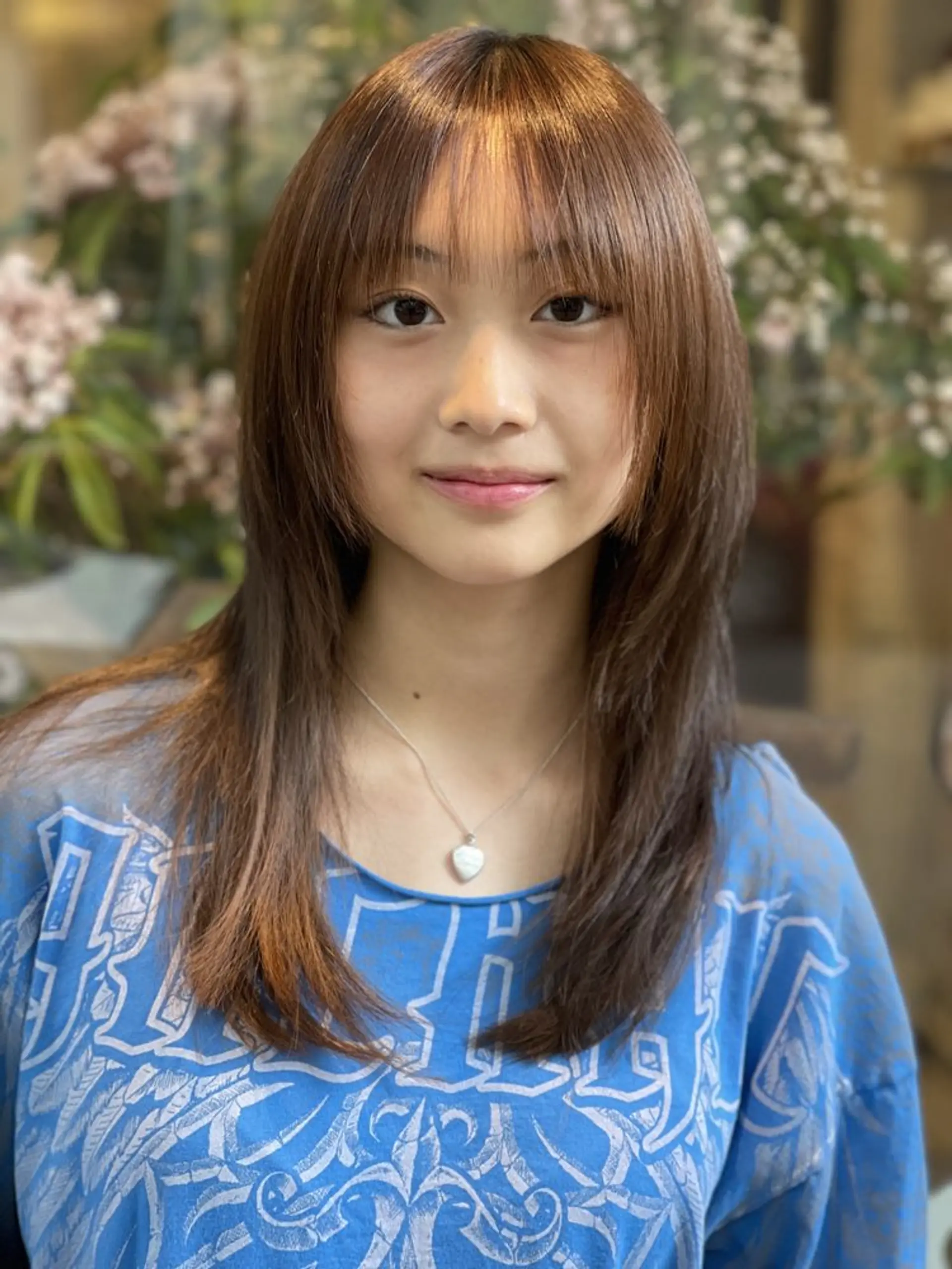 A trendy shag haircut with face-framing curtain bangs and layered ends. 1