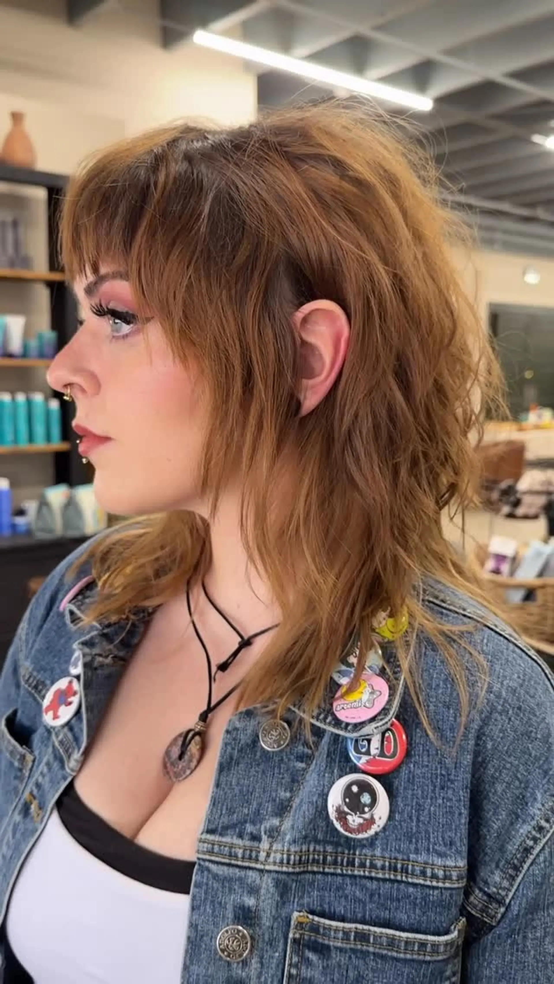A textured mid-length razor shag with choppy bangs and feathered face-framing layers. 1