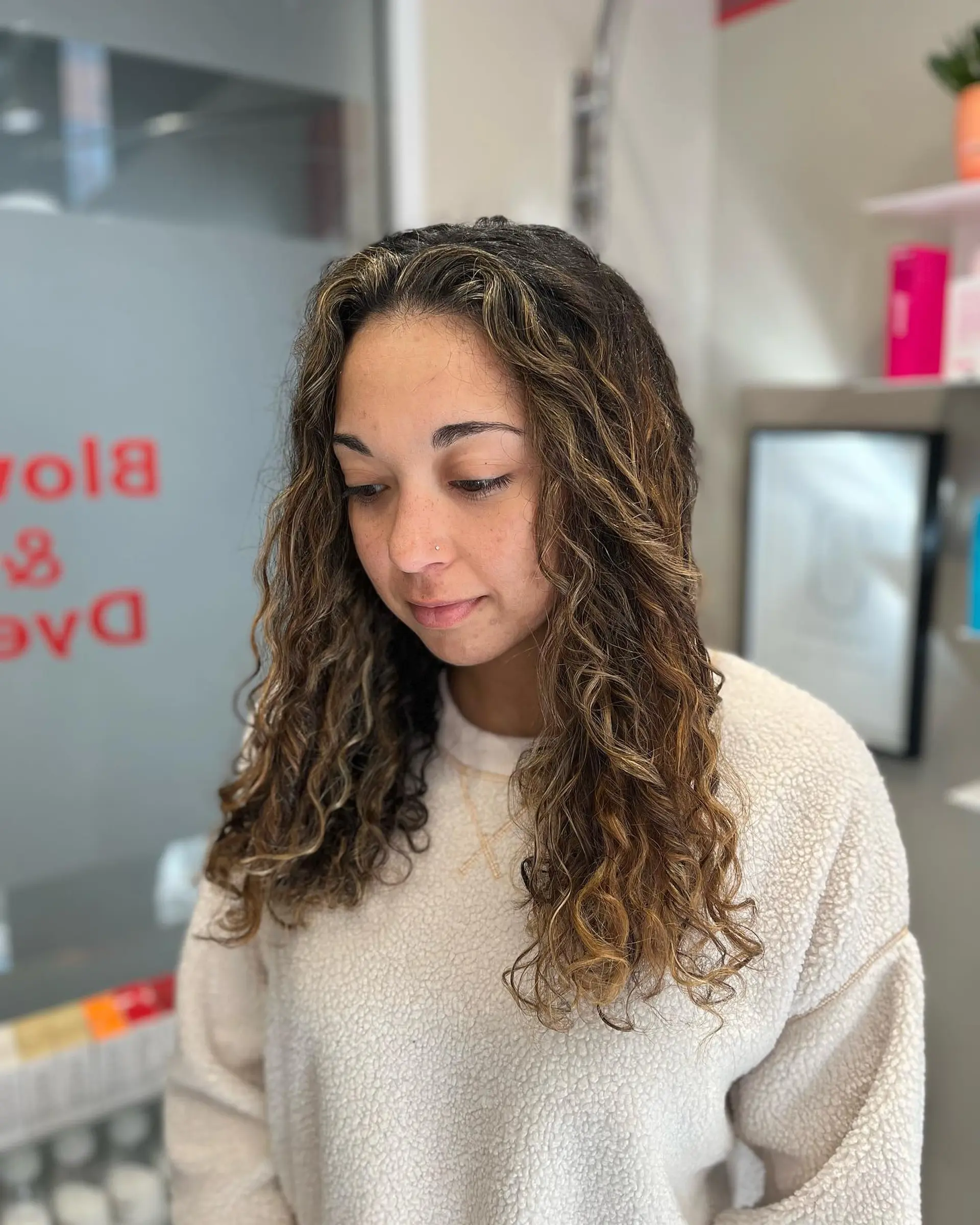 A curly lob with caramel balayage highlights. 1