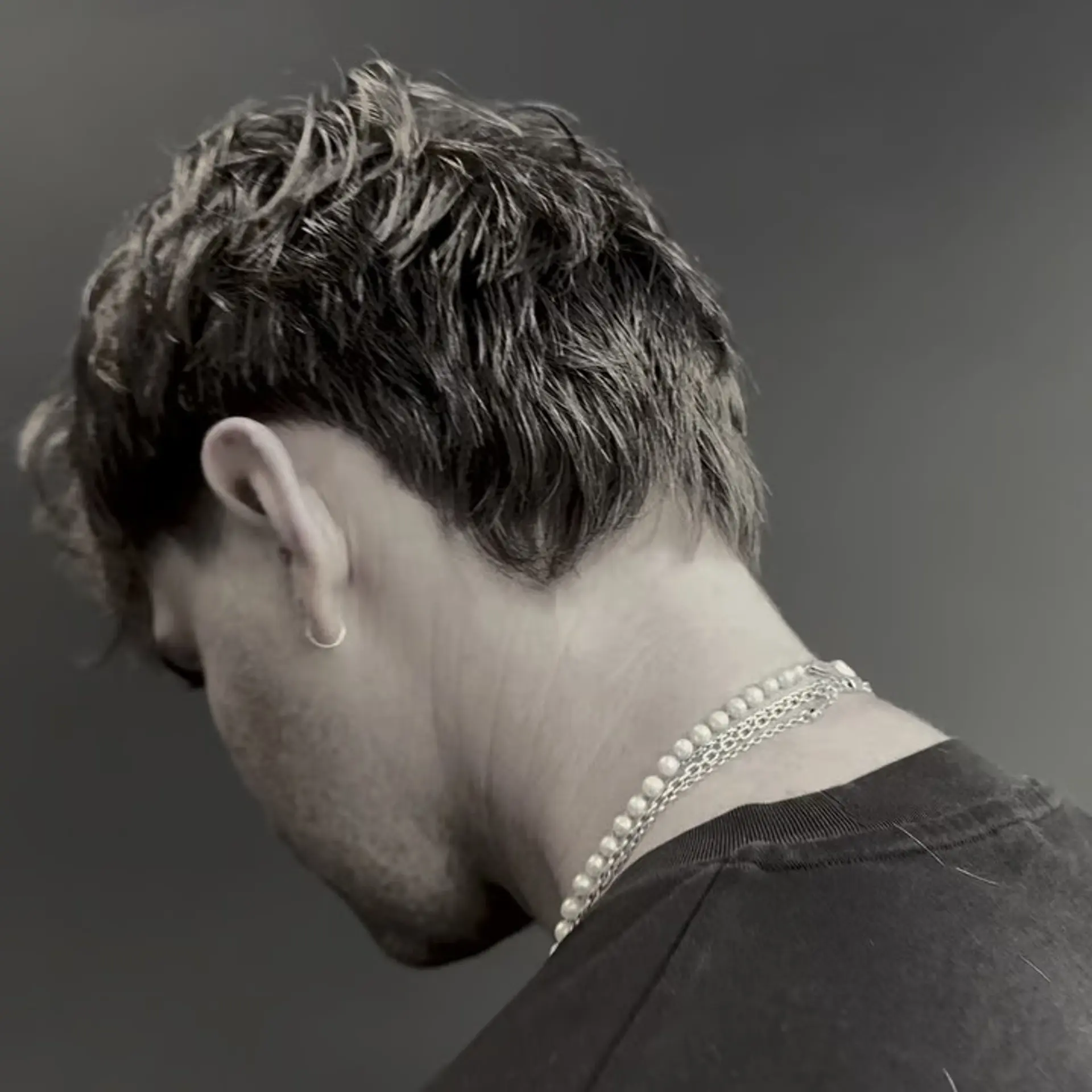 A textured short haircut with piecey, tousled layers and soft tapering around the ears and nape. 1