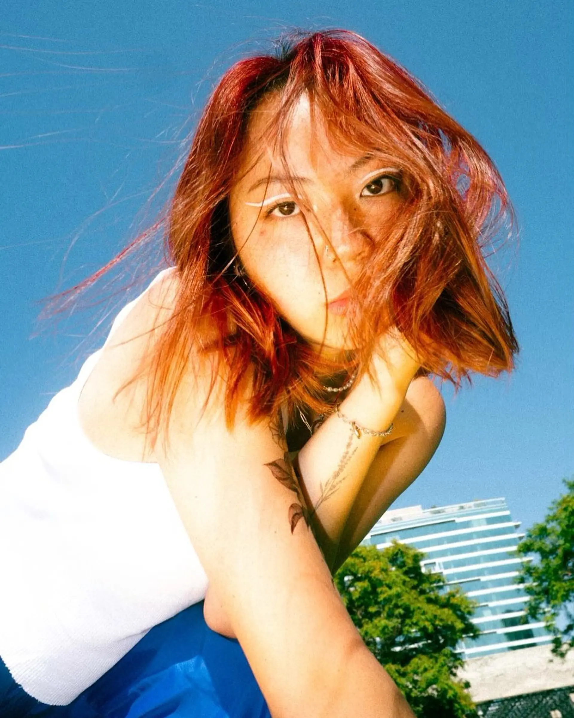 A textured chin-length bob with wispy fringe, finished in a striking all-over copper red tone. 1