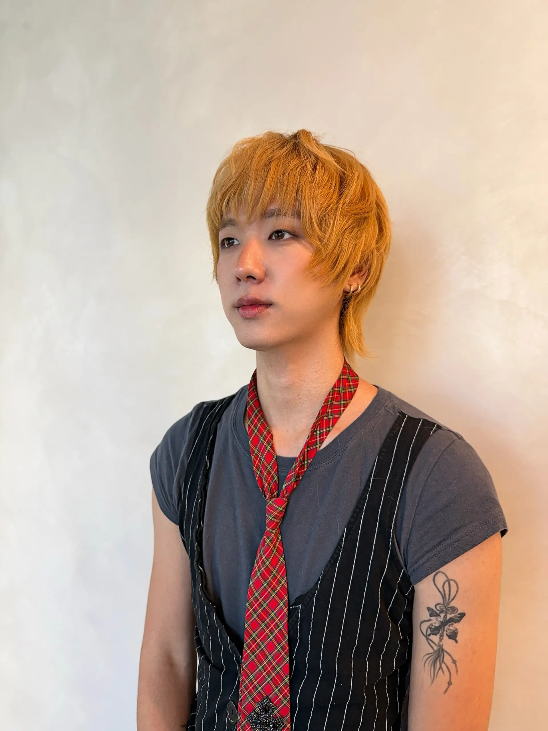 A textured golden blonde shag cut featuring soft, wispy bangs, face-framing layers, and longer piecey length extending down the nape. 1