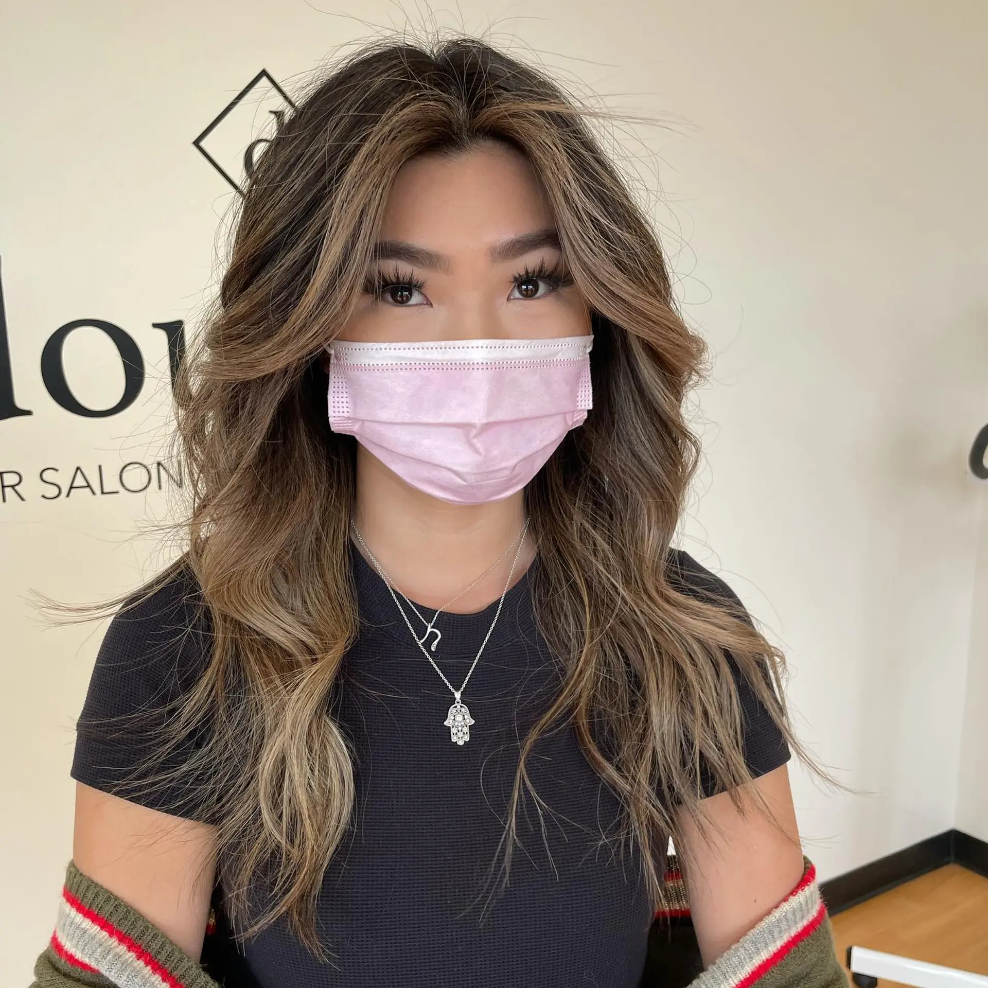 Long dimensional waves featuring bright, face-framing caramel highlights against a deep brunette base. 1