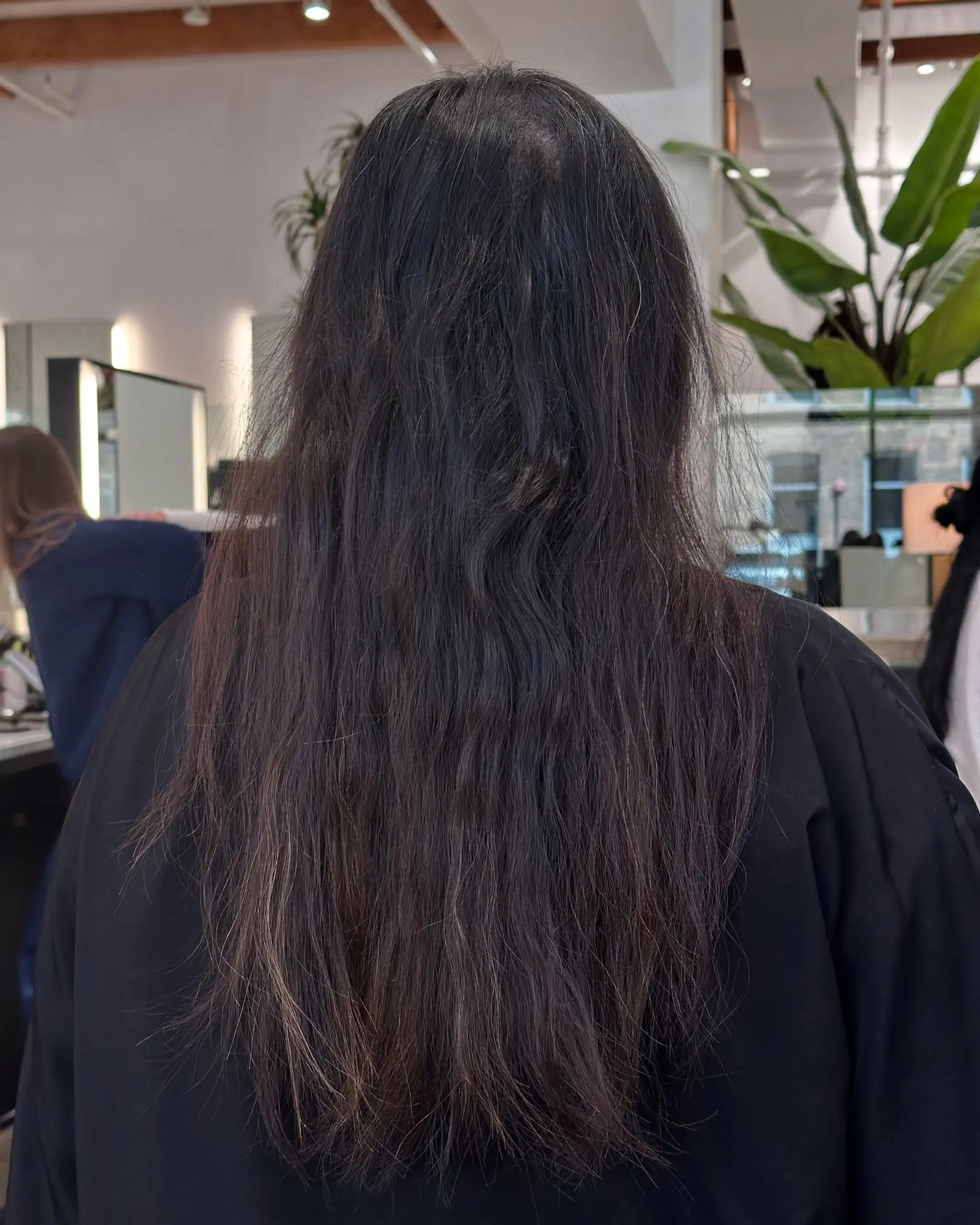 Long, wavy hair with a bronde balayage that transitions from dark roots to light blonde ends. 2