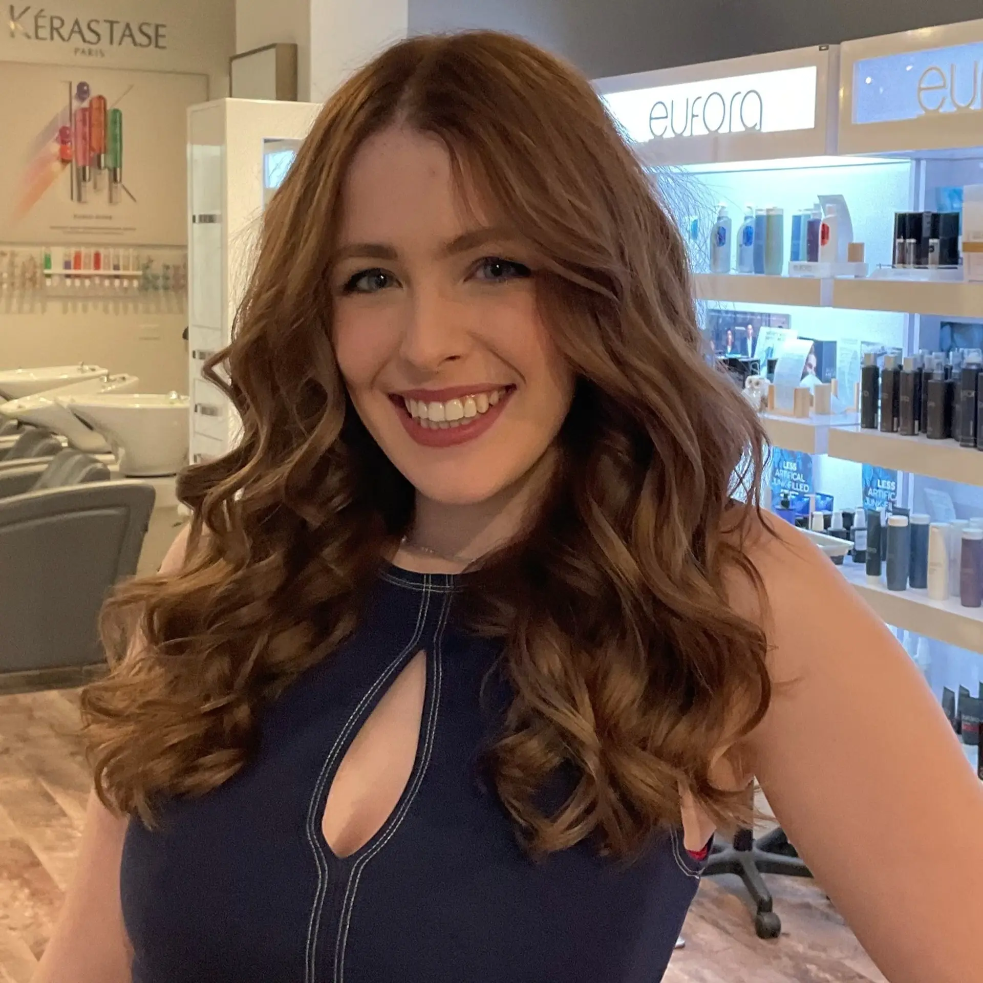 Wavy medium-length hairstyle with copper and auburn tones. 2