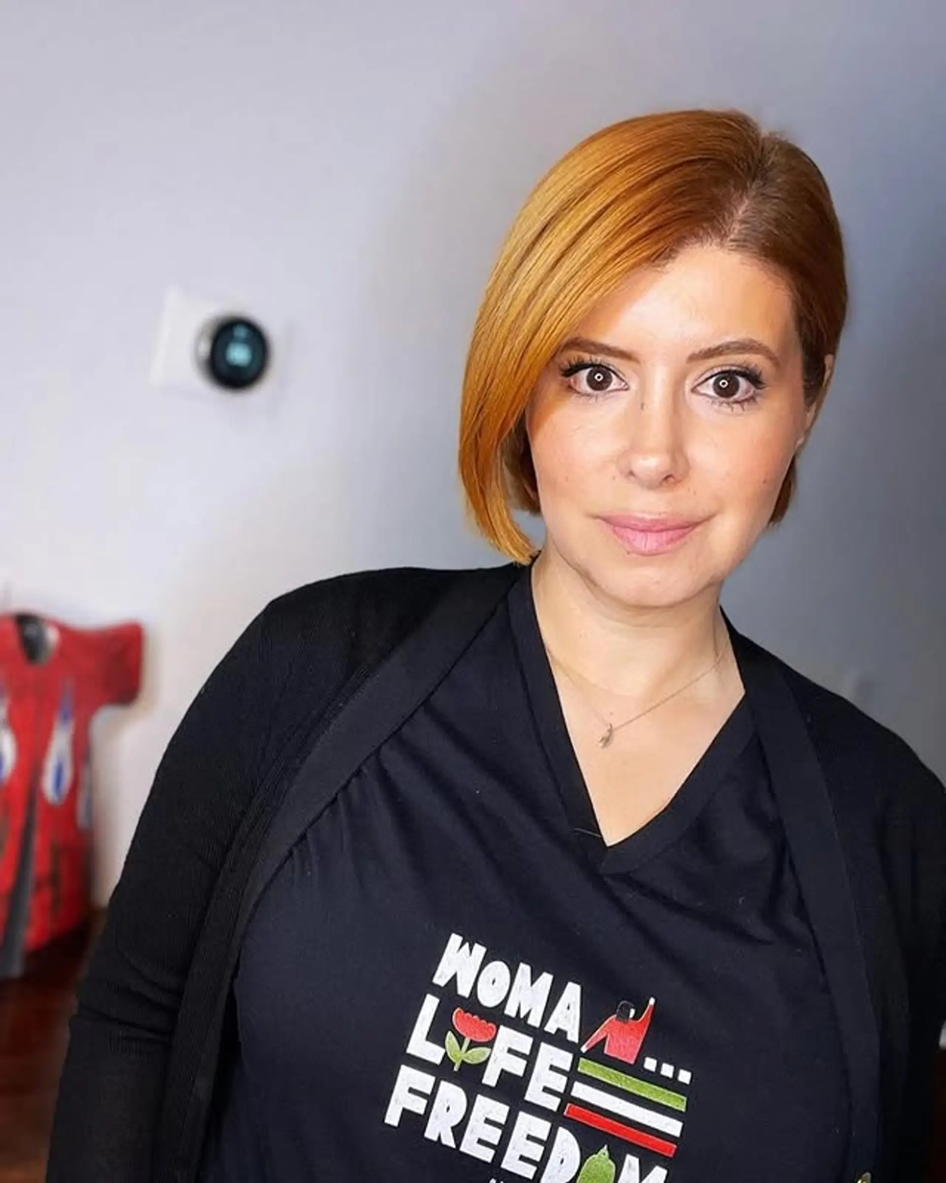 A short, straight bob haircut with a side part. 1