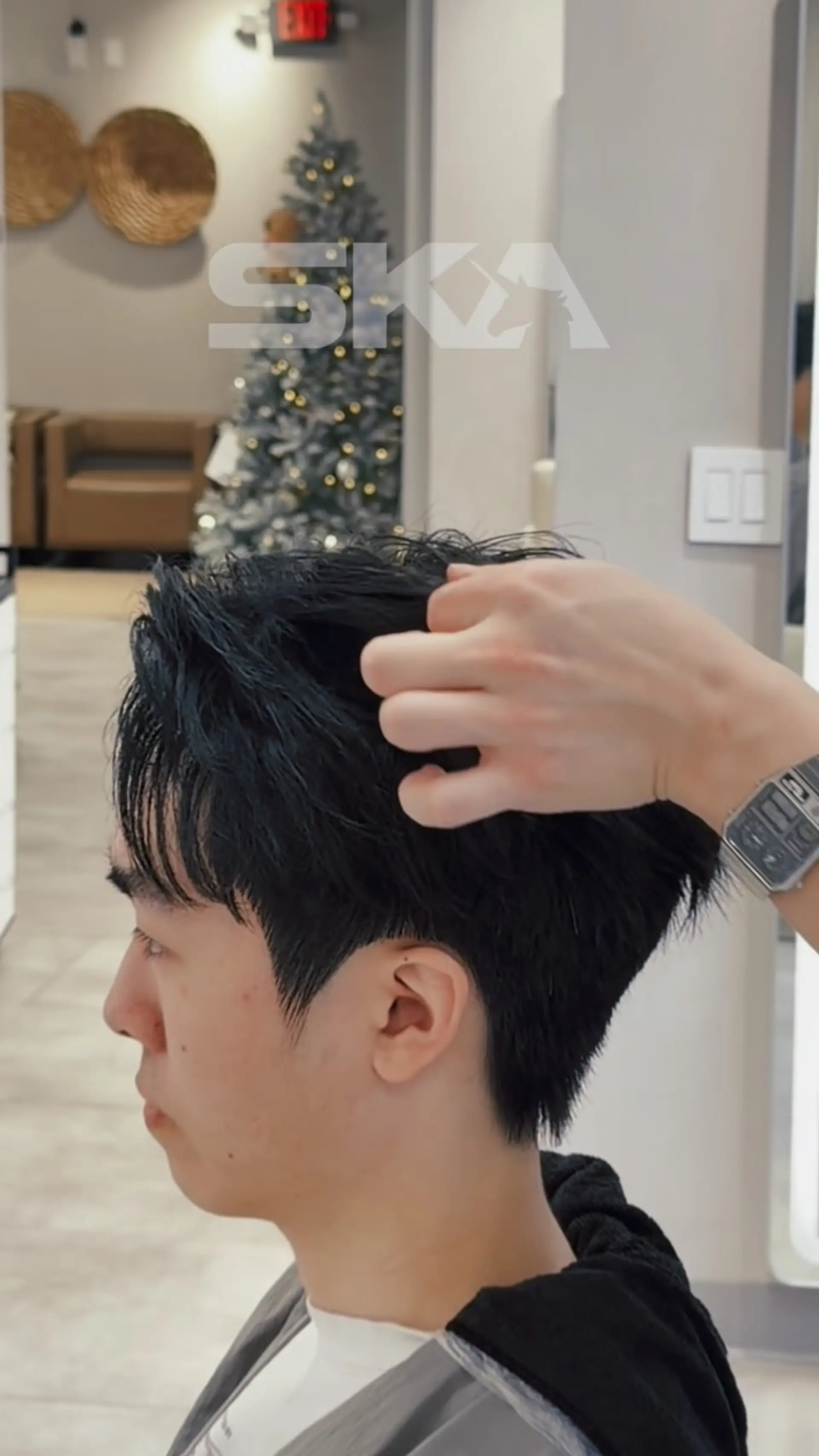 A short, piecey textured haircut with a clean taper around the ears and nape, complemented by layered fringe. 1