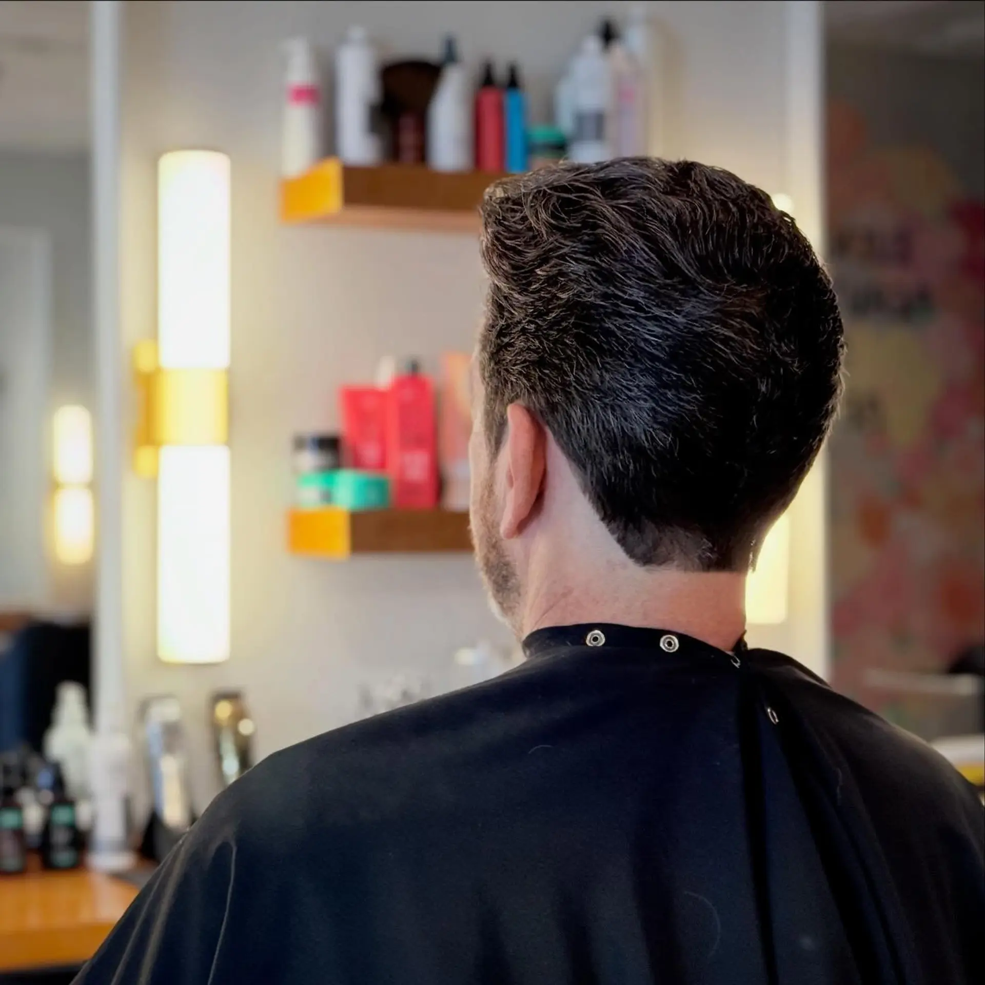 A classic men's short haircut featuring a cleanly tapered neckline with soft, natural texture through the crown. 1