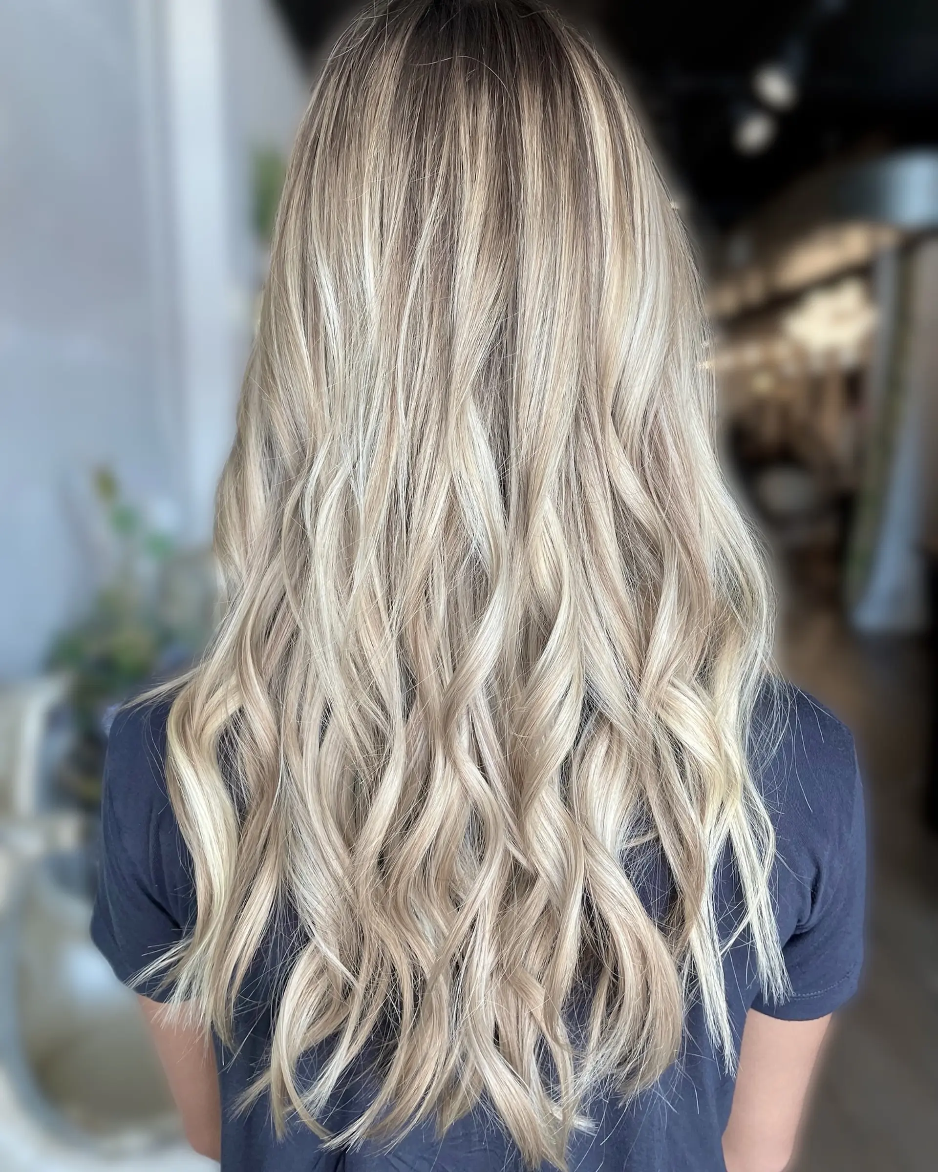 Long, bright blonde hair with seamless dimensional highlights styled in loose, flowing waves. 1